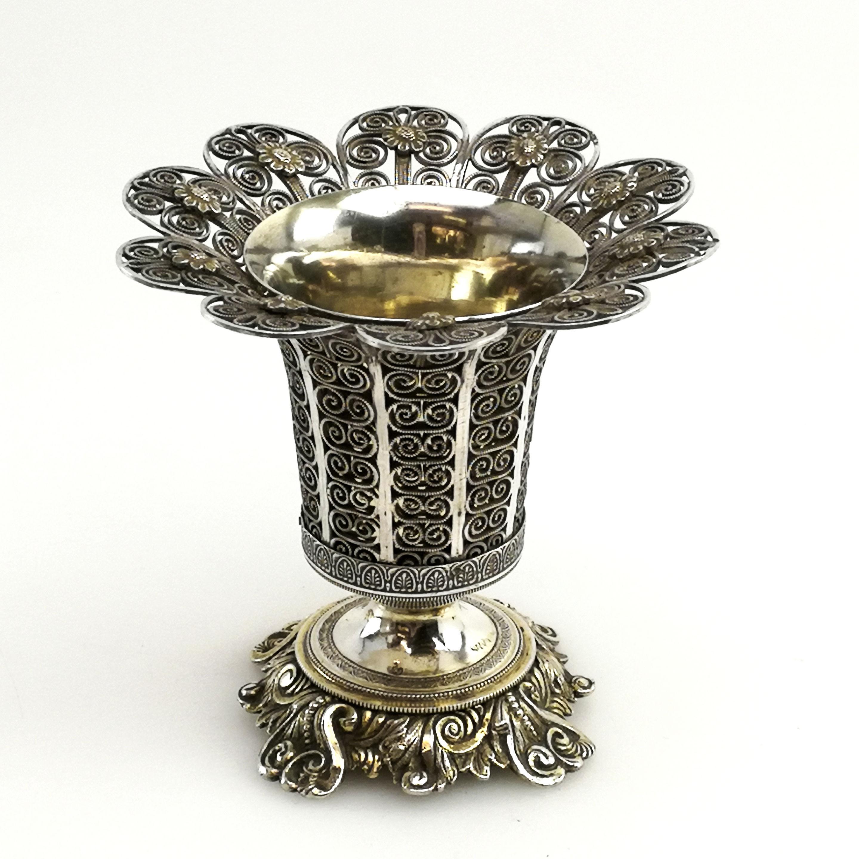 A gorgeous antique Turkish solid silver spoon vase / spoon holder. This trumpet shaped Vase stands on a chased silver base and the body of the vase is created in filigree patterned panels. The vase has a removable silver liner that has been lightly