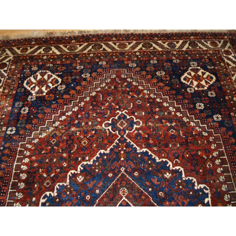 Old carpet with tribal design, Shiraz region, probably by settled weavers from the Khamseh or Qashqai tribe.

A good carpet with large single medallion, the carpet contains many tribal design elements. The carpet has excellent soft wool and a very