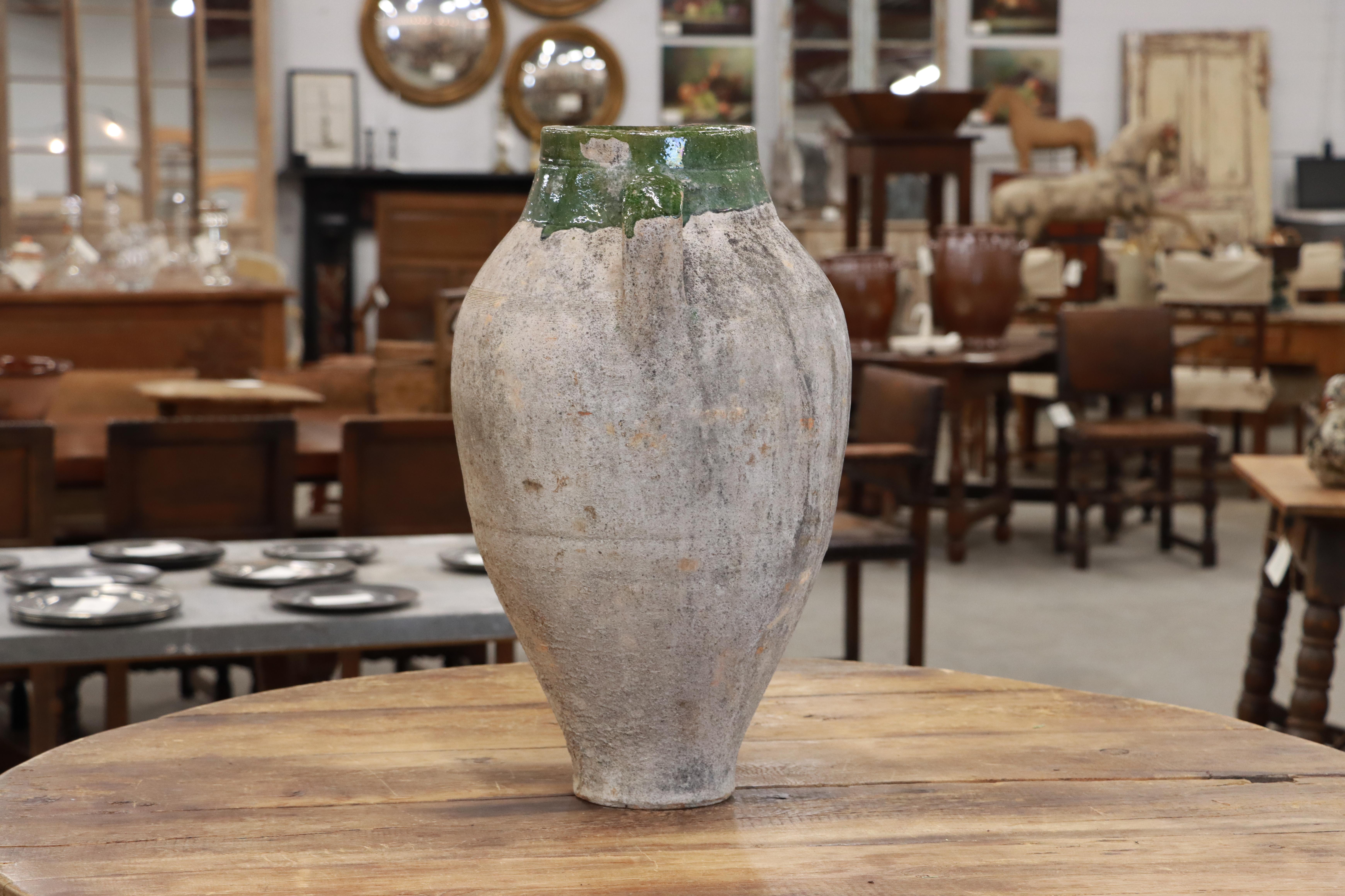 Antique terracotta twin handled olive oil pot. Lovey green glazing around rim and top of handles.