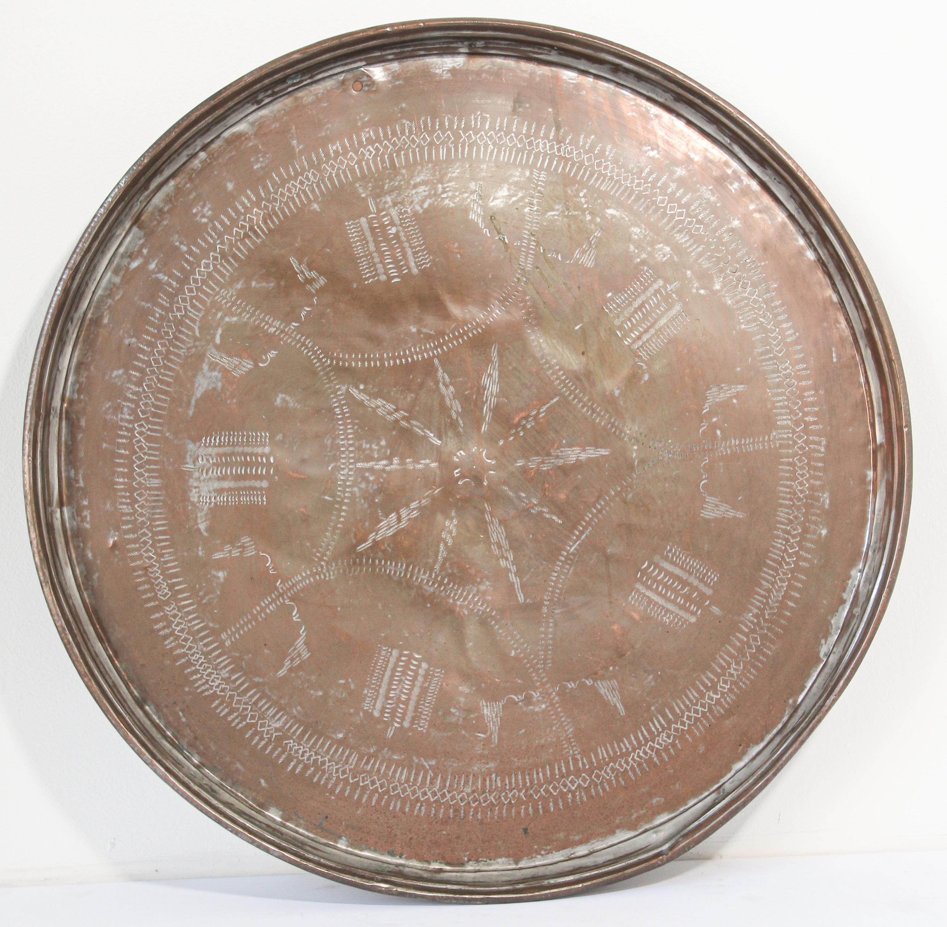 Turkish Asian tin copper round tray.
Antique Turkish tinned copper circular serving tray.
Very nice unusual Asian copper metal decorative hanging tray platter.
The tinned copper patinated tray is etched and hammered with interlacing geometrical