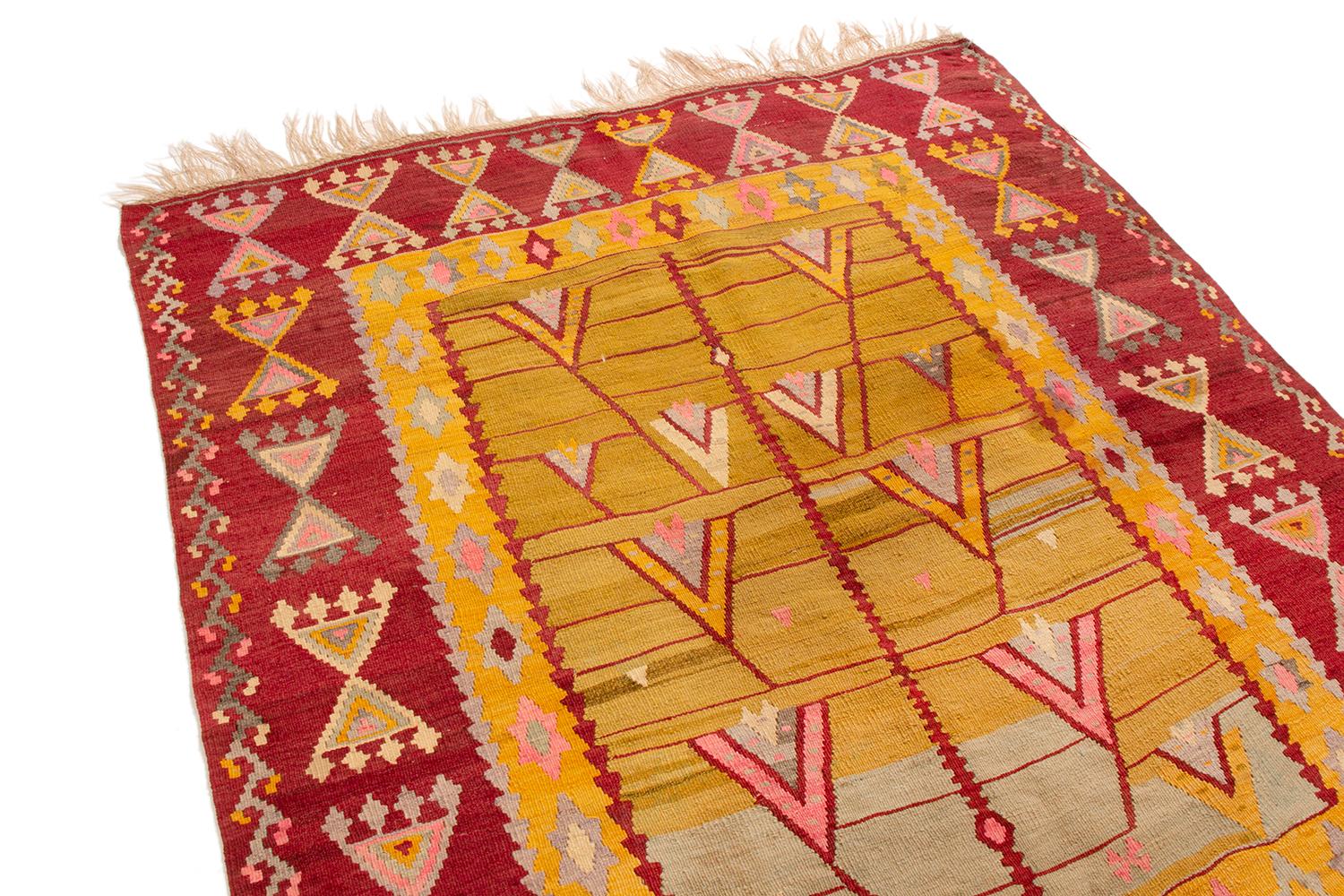 Originating from Turkey in the 1900s, this antique transitional Kilim rug features seldom-seen Turkish symbolism throughout its wrapping border. Flat-woven in high quality, durable wool, the pictorial field design strongly resembles a natural scene