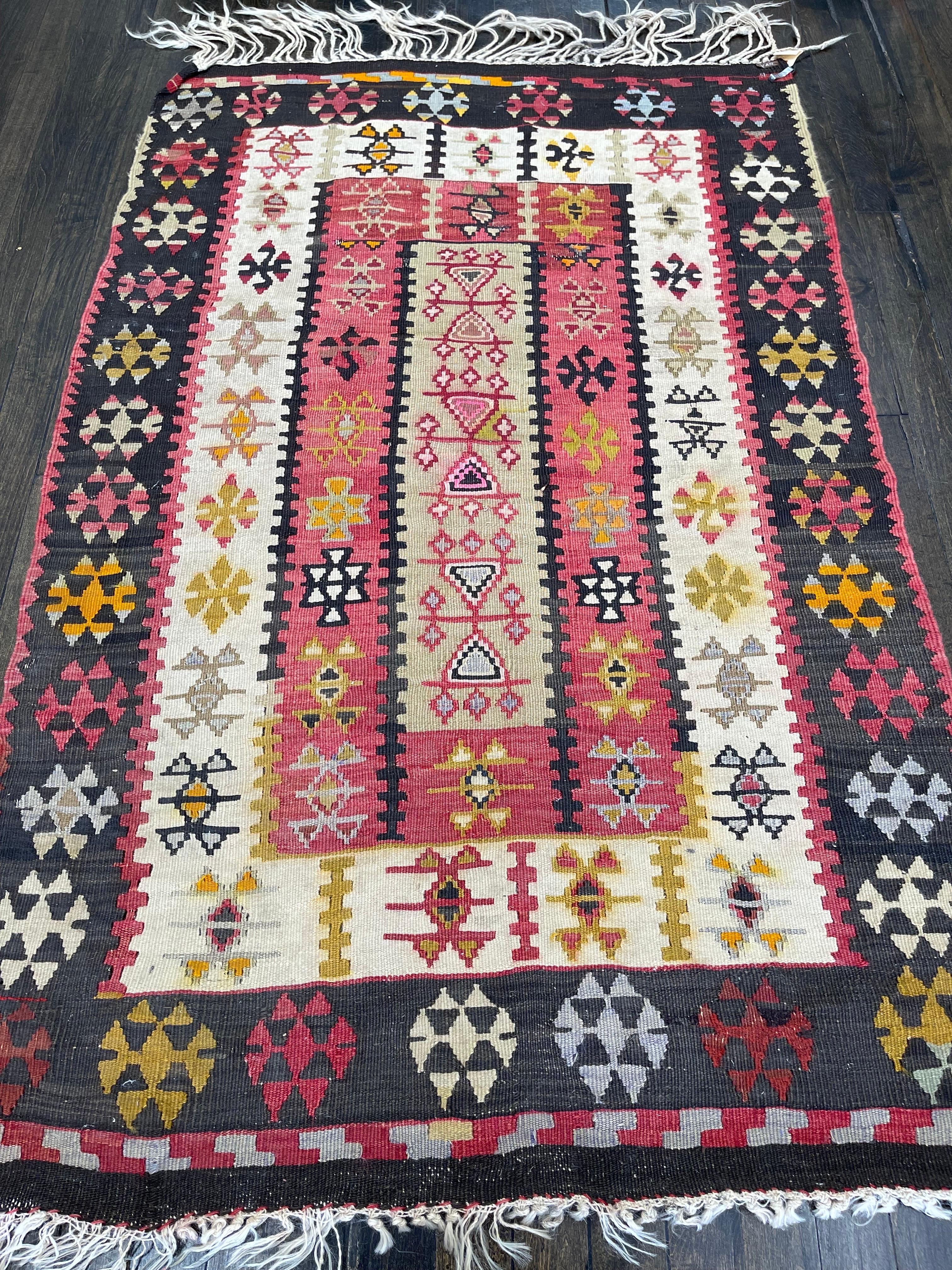 A Fabulous flat weave, this klim was hand woven in the town of Van, one of major areas of klim making in Turkey. Pattern consists of three rectangles decorated by rows of rosettes and other ornaments and the whole rug is framed by a graceful black