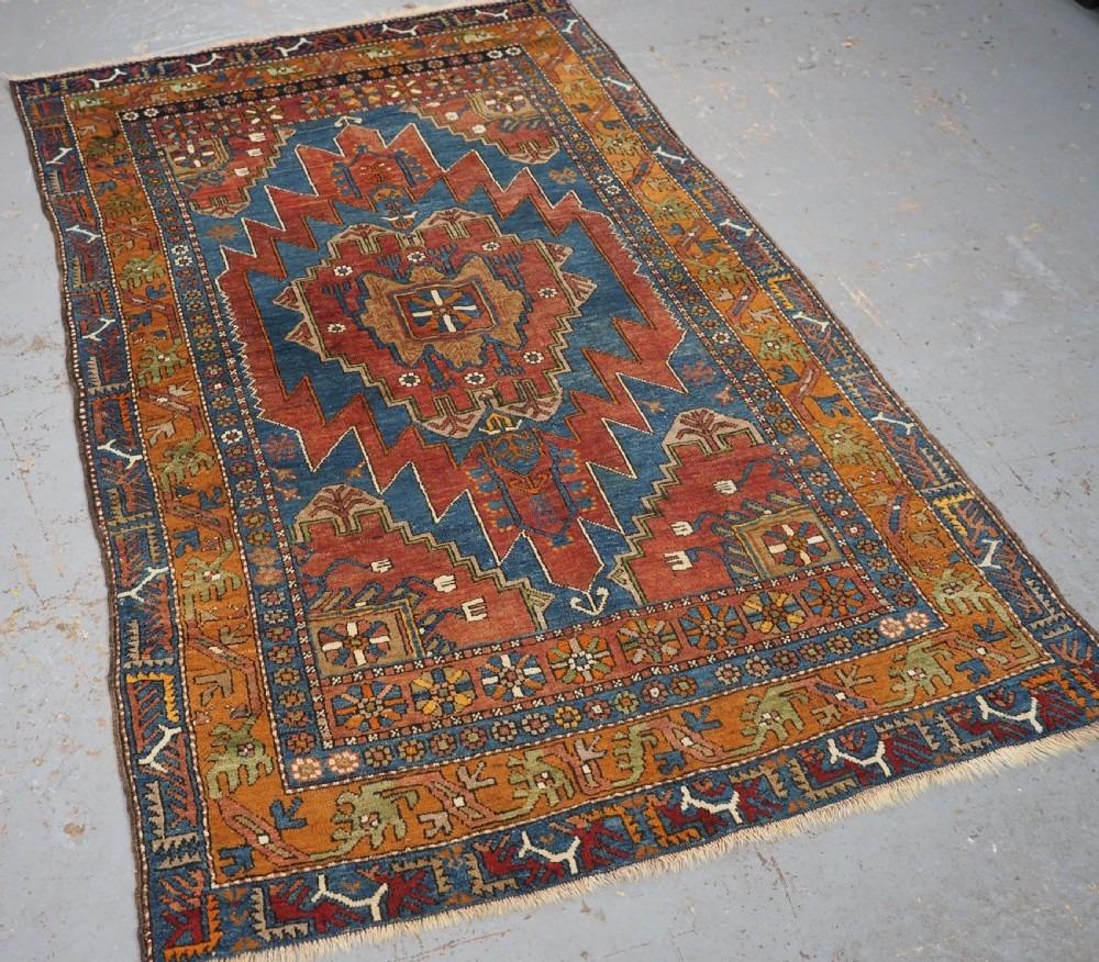 Antique Anatolian Yahyali rug with traditional medallion design
Circa 1900

A very good example of this classic design with a rustic village charm

The colours work really well with this bold design, the gold border really compliments the rich red