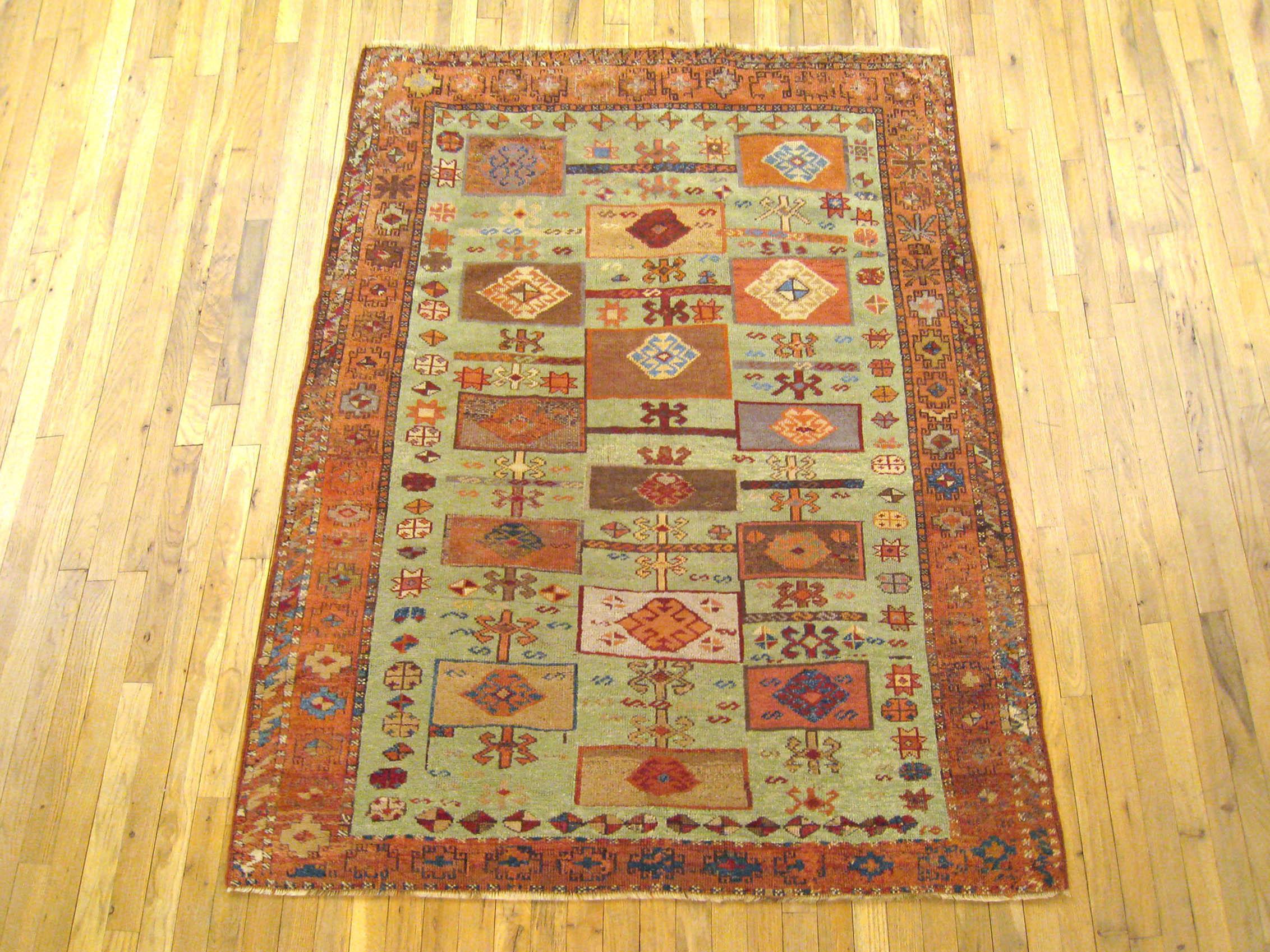 Antique Turkish Yuruk Decorative Oriental Carpet, Small size, with green Field

A gorgeous antique Turkish Yuruk carpet, circa 1900, size 5'4” x 4'7”. This lovely carpet features boxes motifs allover the green central field. The soft red border