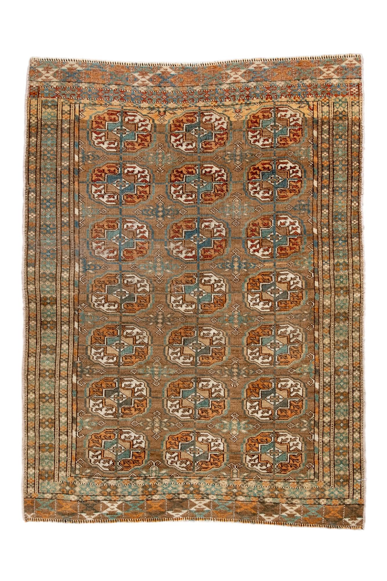  This antique Bokara rug features the classic Tekke-style repeating gül pattern arranged in precise rows across a camel-toned field. Subtle blue and ivory accents add depth, while multiple striped borders complete the traditional Turkmen