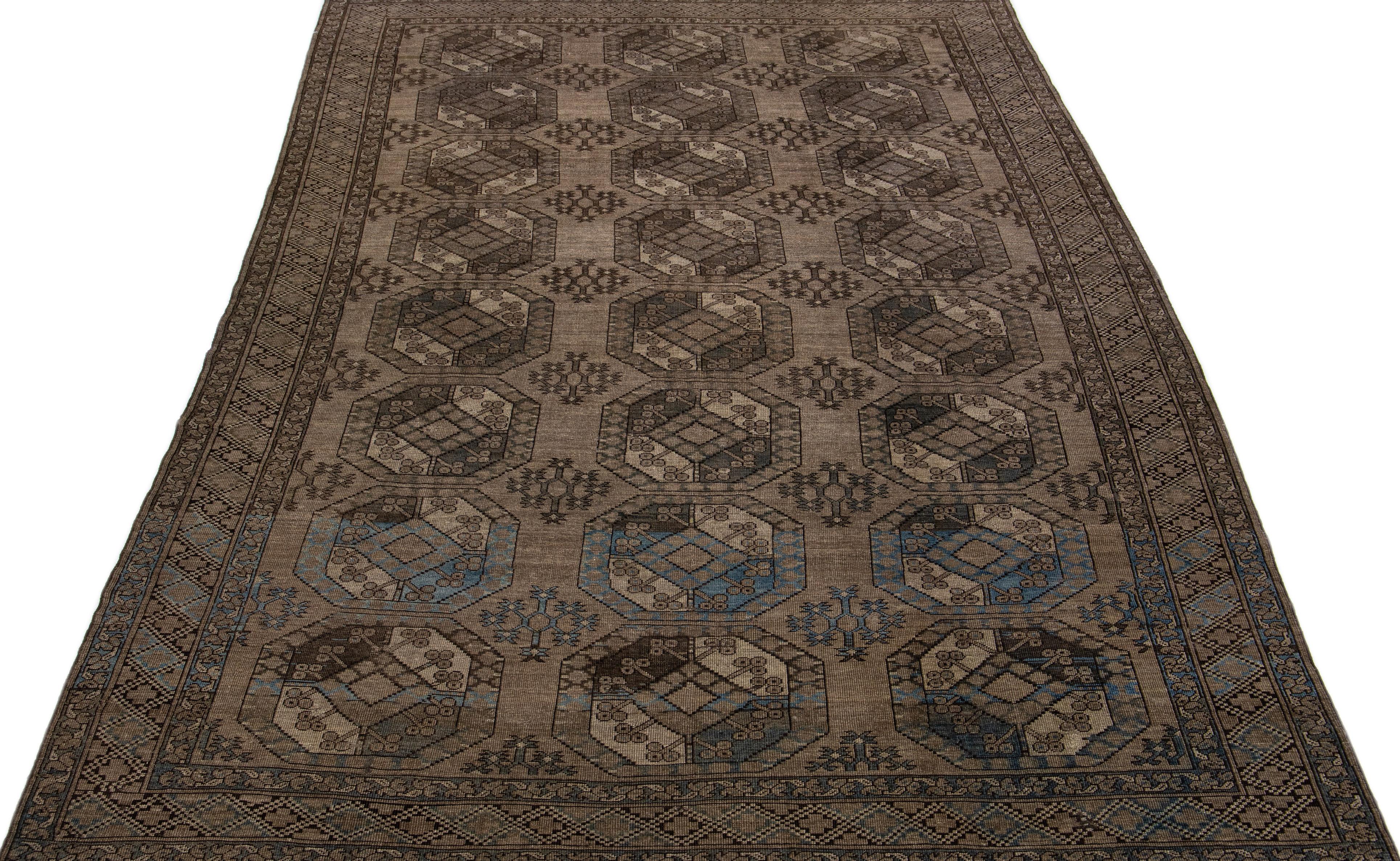 Beautiful antique Turkmen hand-knotted wool rug with a brown color field in a gorgeous all-over Gul pattern design.

This rug measures: 7'5