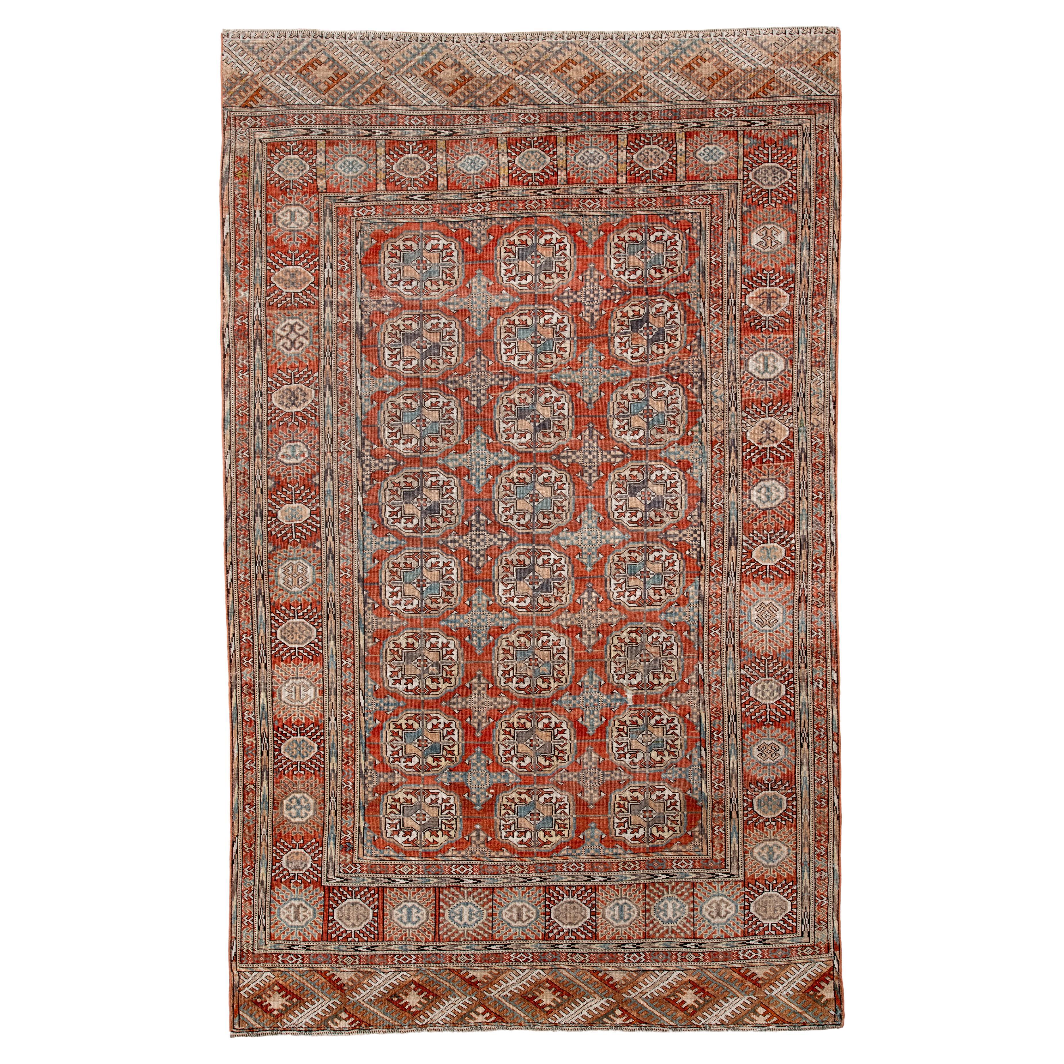 Tappeto antico Turkoman con campo Gül all
aperto in rosso ruggine e blu Steele in vendita