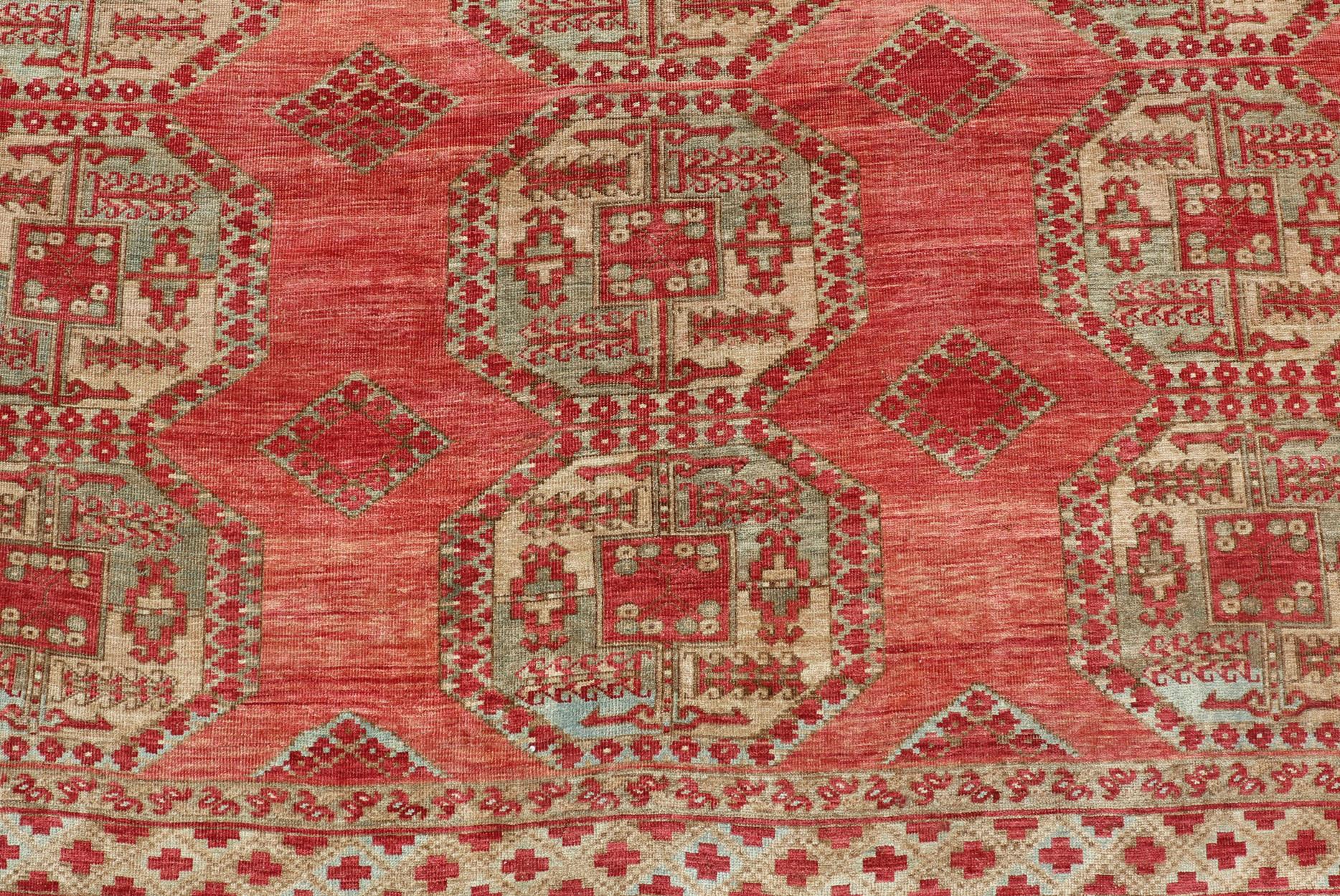 Antique Turkomen Ersari rug with Repeating Gul Design in soft red background, green, light blue, butter yellow. Hand-Knotted Ersari Rug. Keivan Woven Arts; rug EMB-9656-P13592, country of origin / type: Turkestan / Ersari, circa 1930s.

Measures: