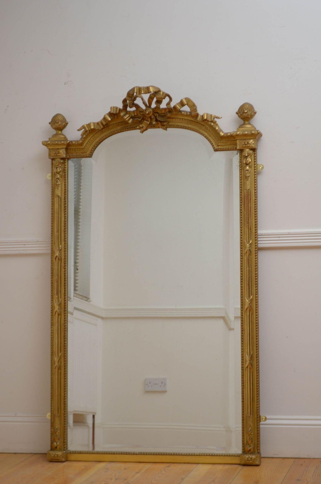 Sn5542 Very elegant turn of the century gilded wall mirror or console table mirror, having original bevelled edge glass with some foxing in arched and beaded with bow crest to the centre flanked by acorn finials, reeded half columns and decorative