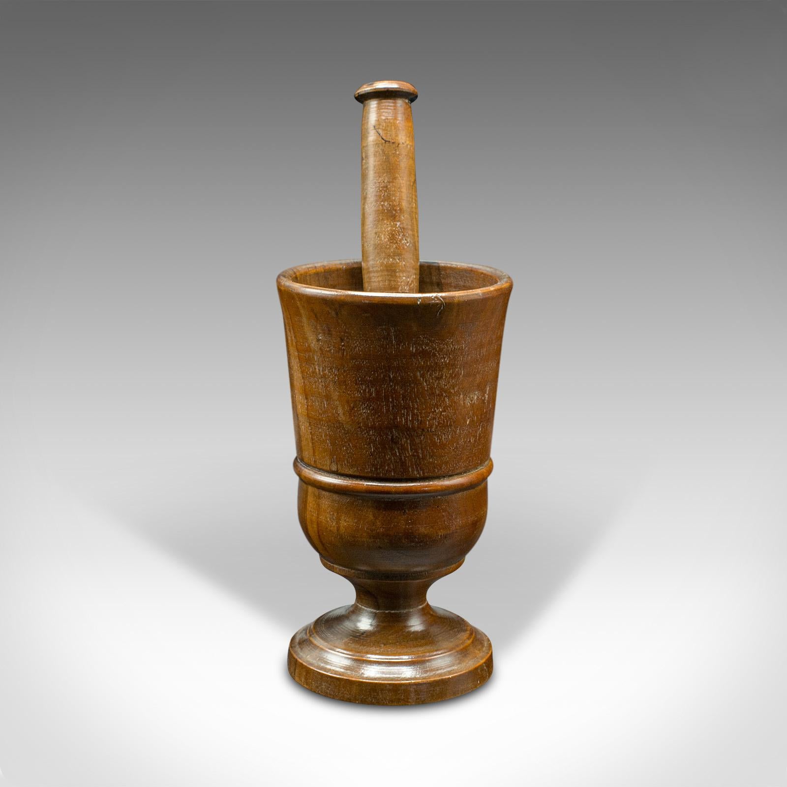 This is an antique turned mortar and pestle. An English yew decorative treen, dating to the late Victorian period, circa 1900.

A darling kitchen or apothecary mortar and pestle
Displays a desirable aged patina and in good order
Yew stocks show