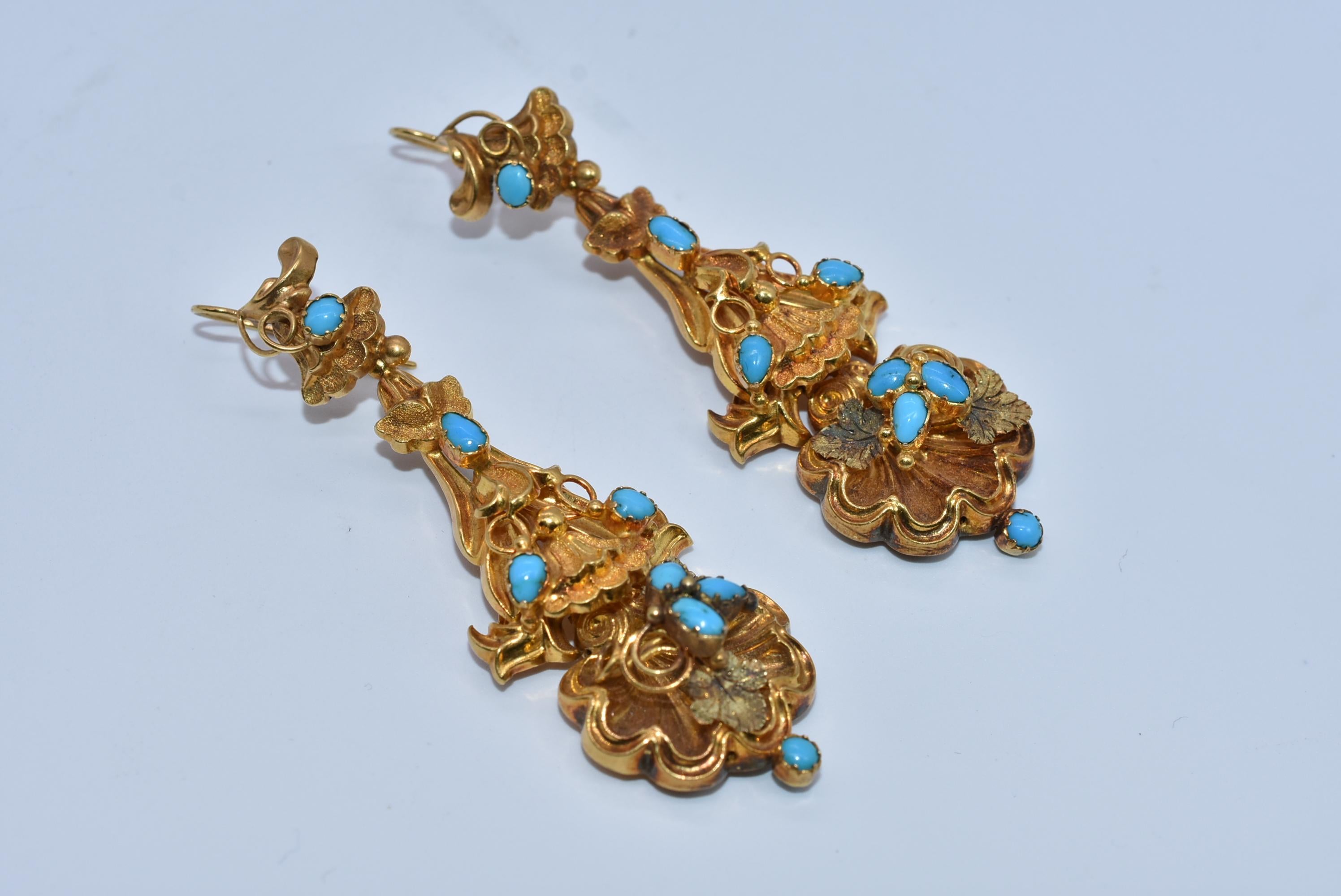 Three inch long day-night  gold earrings with a lovely rococo design that incorporates foliate and shell motifs set with Persian turquoise and enlivened by the two-color 15K gold. The earrings have a secure hook on the back of the drop part of the