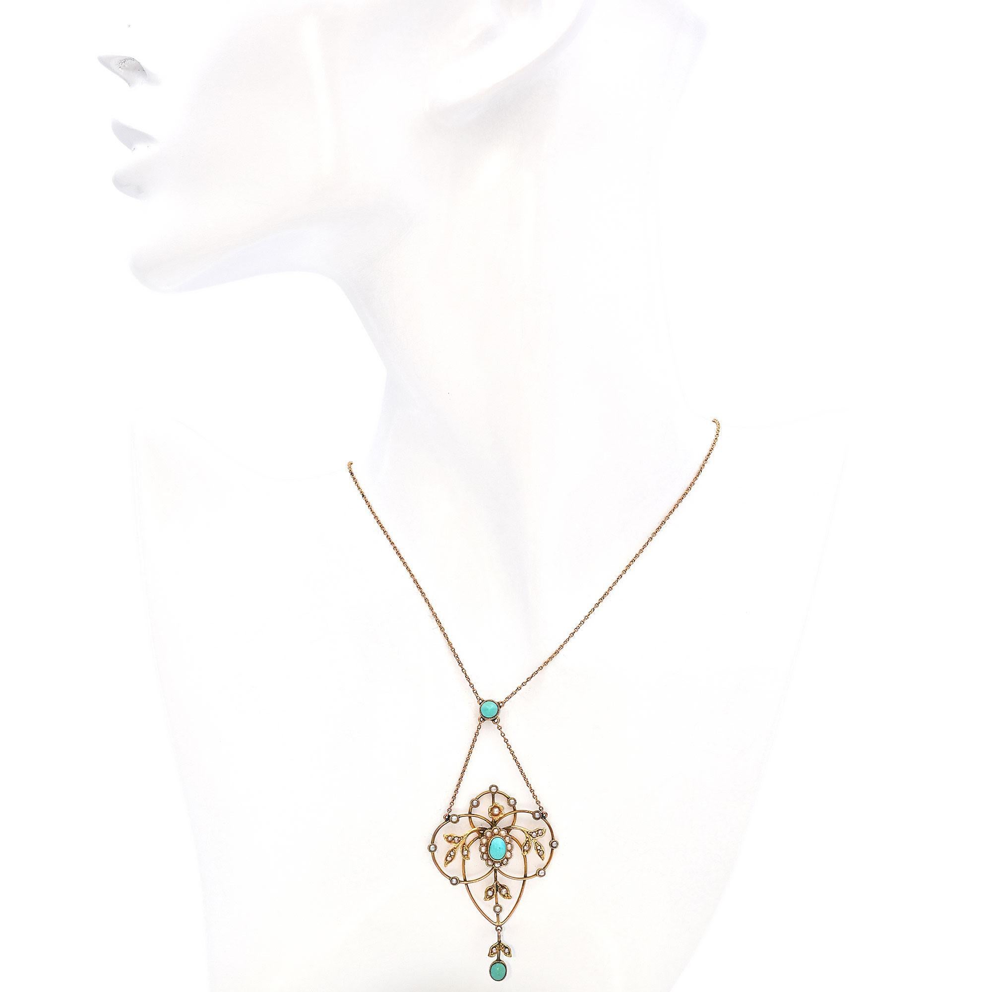 Crafted in buttery yellow gold, this stunning piece showcases a central turquoise stone, surrounded by a halo of small pearls. The pendant's design includes elegant, flowing curves and leaf motifs adorned with additional pearls, creating a