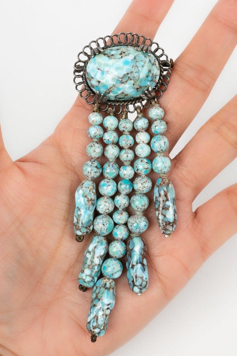 Not signed - Vintage brooch in glass paste with turquoise stones effect and dark silver metal.

Additional information:
Condition: Very good condition
Dimensions: Length: 11 cm - Maximum width: 4 cm

Seller Reference: BR72