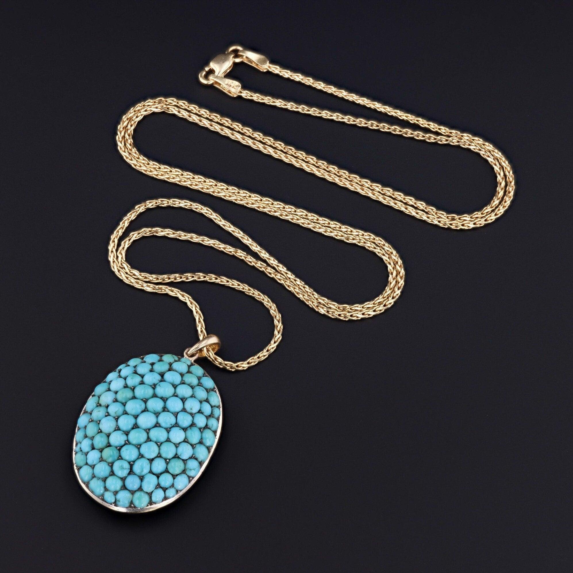 An eye catching turquoise pendant created from an antique Victorian brooch (circa 1870-1890)!

This dramatic pendant delights the eyes with vibrant turquoise cabochons mounted silver with a 14k gold domed back and 14k gold bail.

The pendant