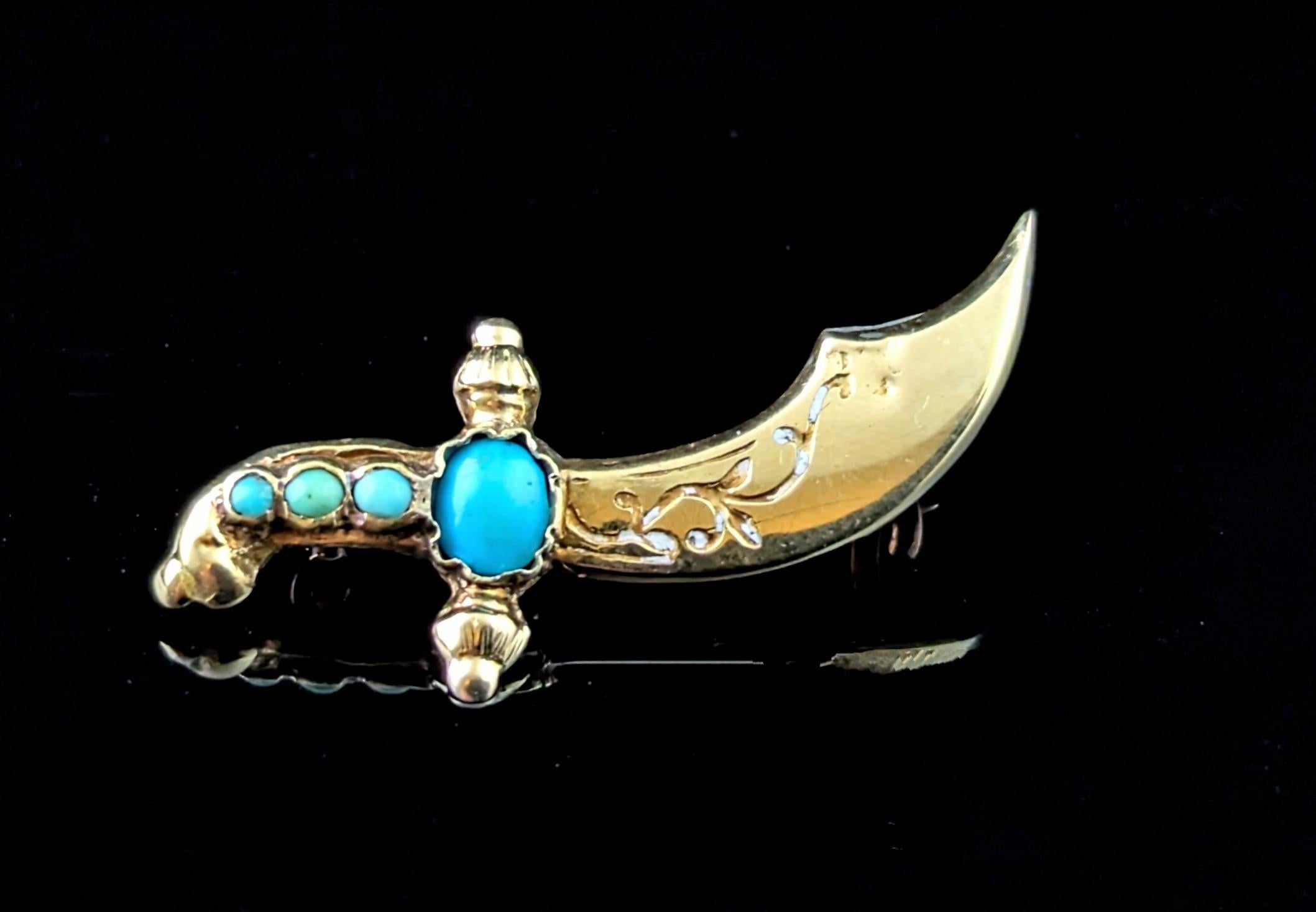 A wonderful antique Turquoise Kukri dagger brooch.

Modelled as the decorative traditional Kukri style Indian dagger in 9ct yellow gold it is set to the hilt with three small turquoise cabochons followed by a larger blue toned turquoise cab.

The