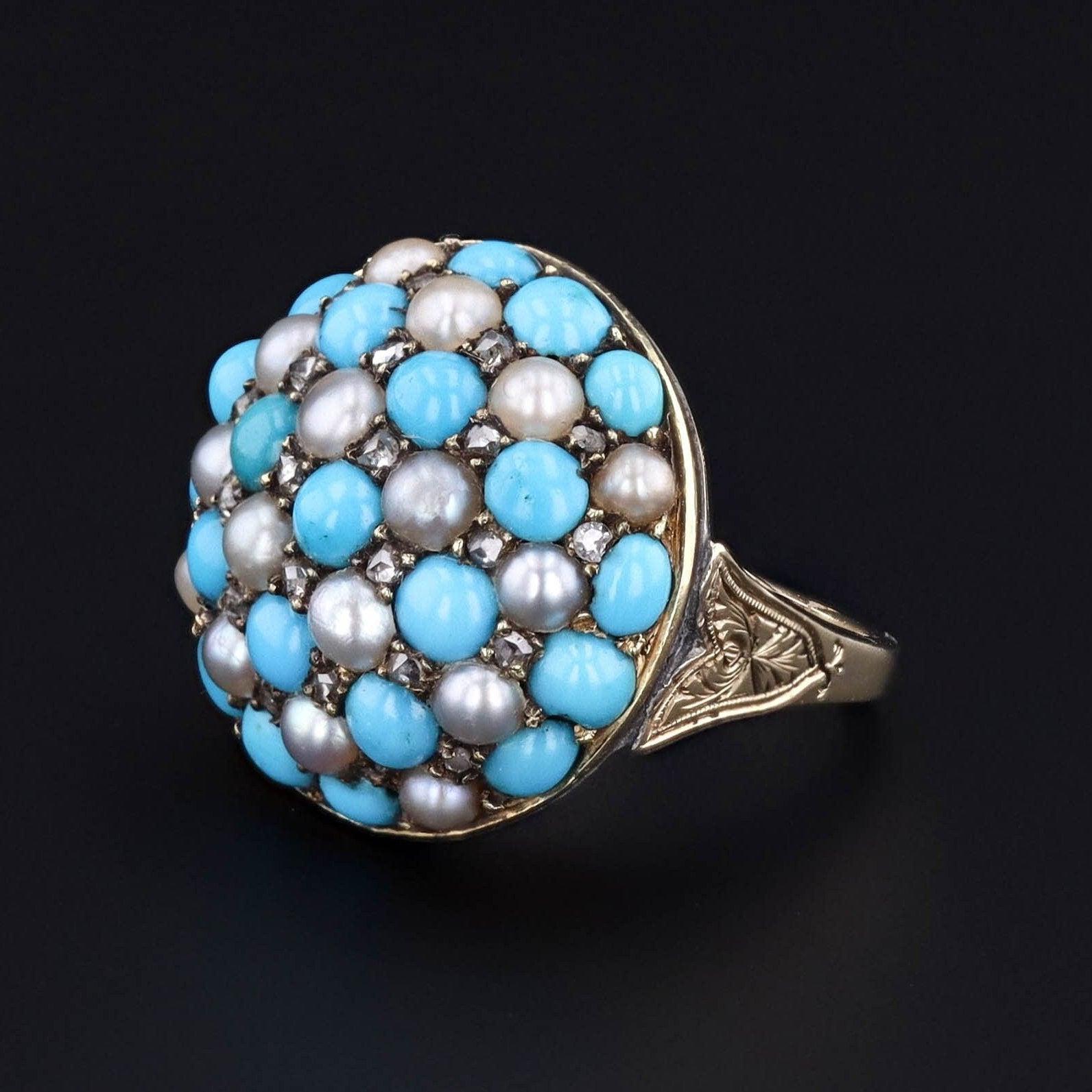 Rich blues and shimmering whites have us feeling the sky and the sea with this domed Victorian ring!

Made up of a combination of turquoise, pearls and diamonds, this 14k gold checkerboard ring (circa 1860-1880) also features detailed etchings along