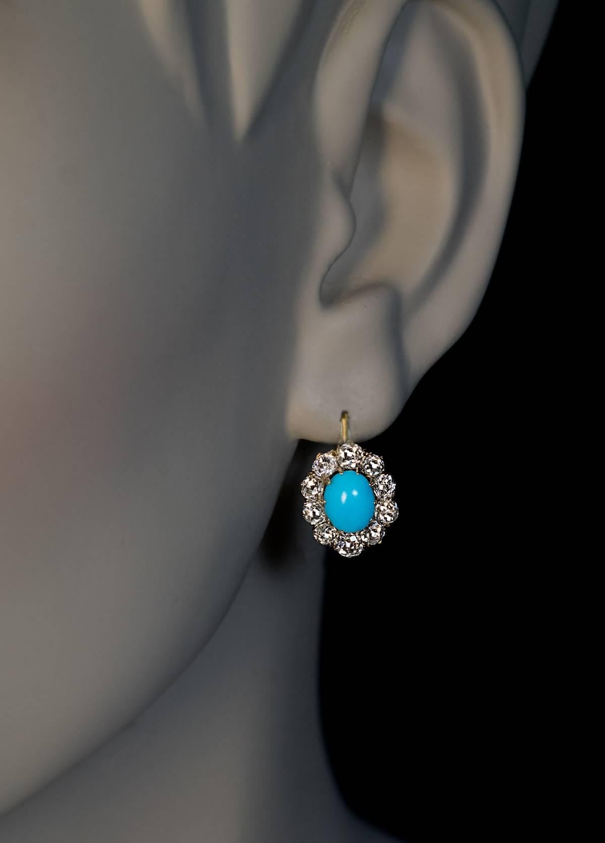 Circa 1890

Victorian era antique 14K gold cluster earrings are centered with oval sky blue cabochon turquoise encircled by sparkling bright white old mine cut diamonds (F-G color, VS-SI clarity).

Estimated total diamond weight is 2.60 ct.

The