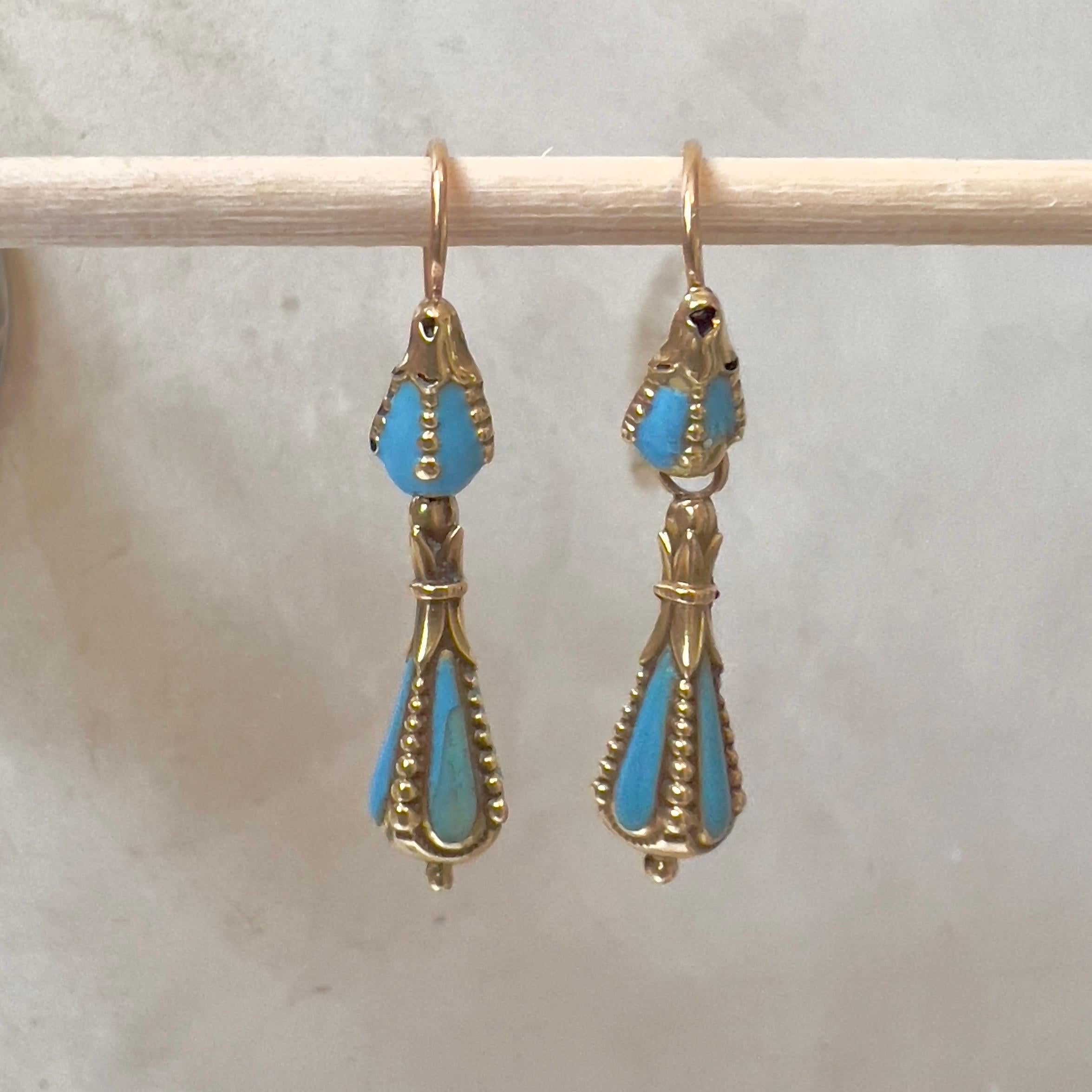 An antique pair of 14 karat gold drop earrings set with turquoise turquoise enamel and gold granulation.

Transport yourself to a bygone era with these exquisite antique 19th century turquoise enamel 14 Karat gold drop earrings. Crafted with