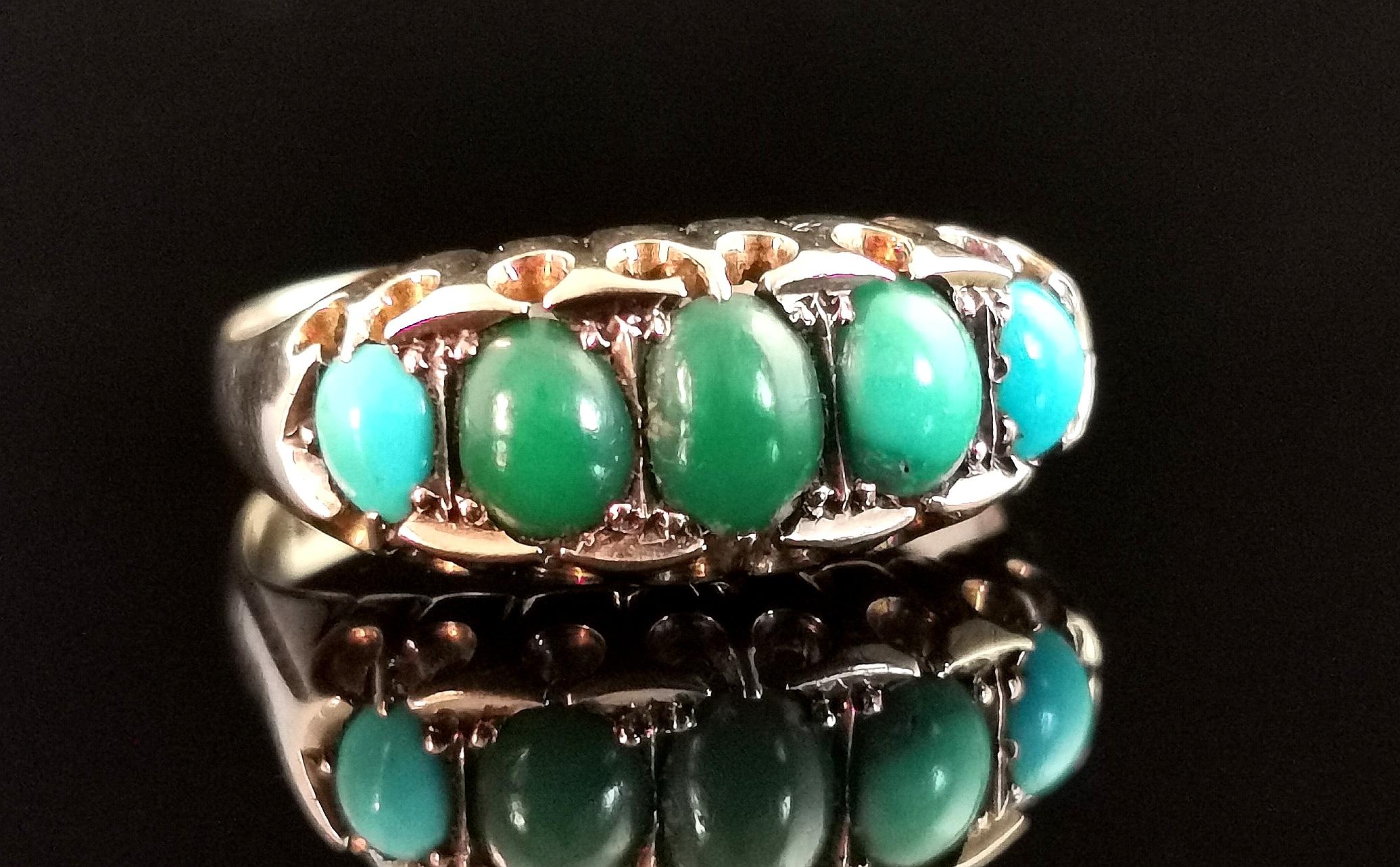 A gorgeous antique variegated Turquoise five stone ring.

This superb ring has five rich green turquoise cabochons set to the front, graduating in size from the largest centre stone.

It is crafted in a rich lightly rosey 9ct gold with a boat head