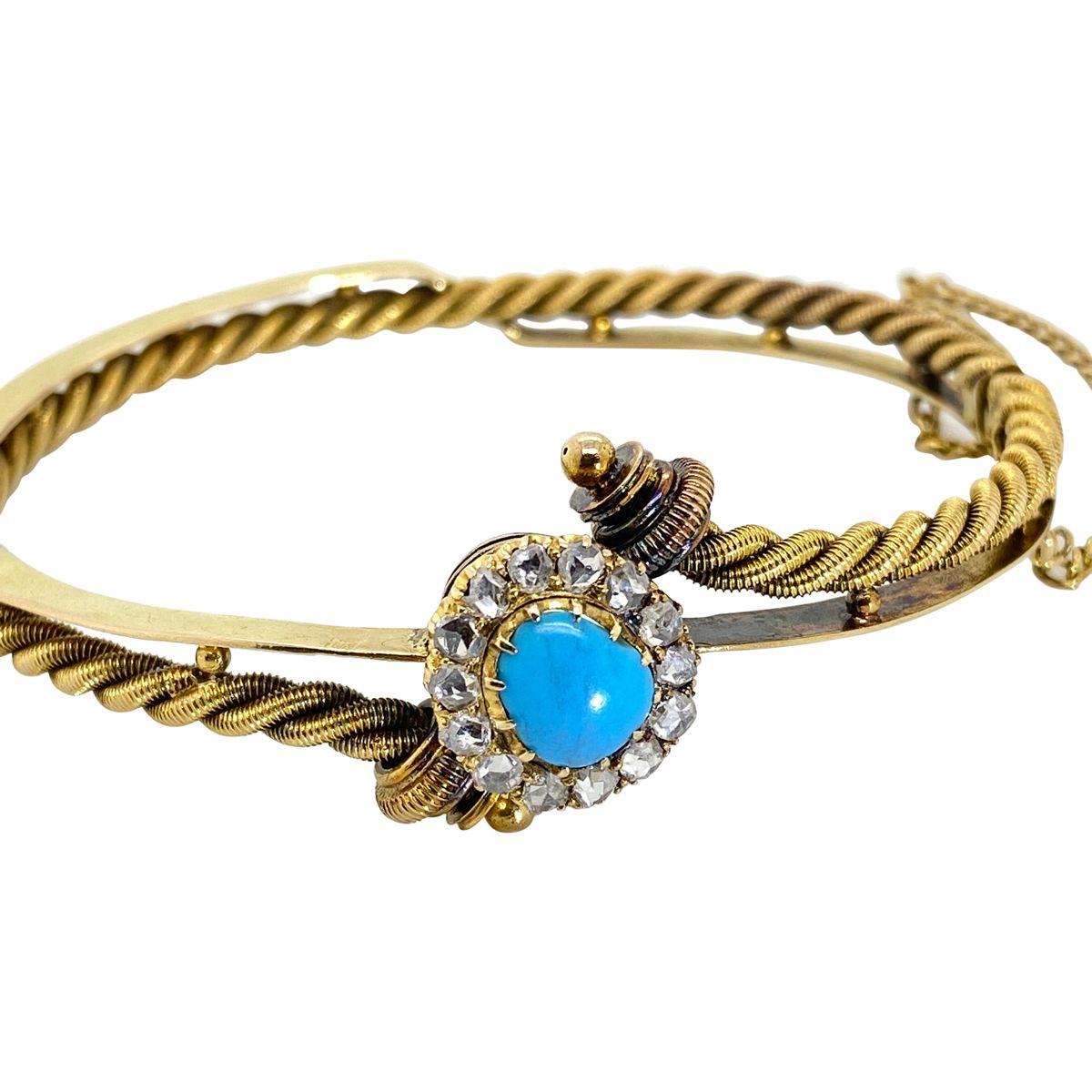 A one-of-a-kind bangle with a unique style and definitely a head turning piece. Fashioned from 14k yellow gold the bangle features a central duck egg blue elongated oval shaped natural turquoise claw set and surrounded by 14 rose cut white diamonds