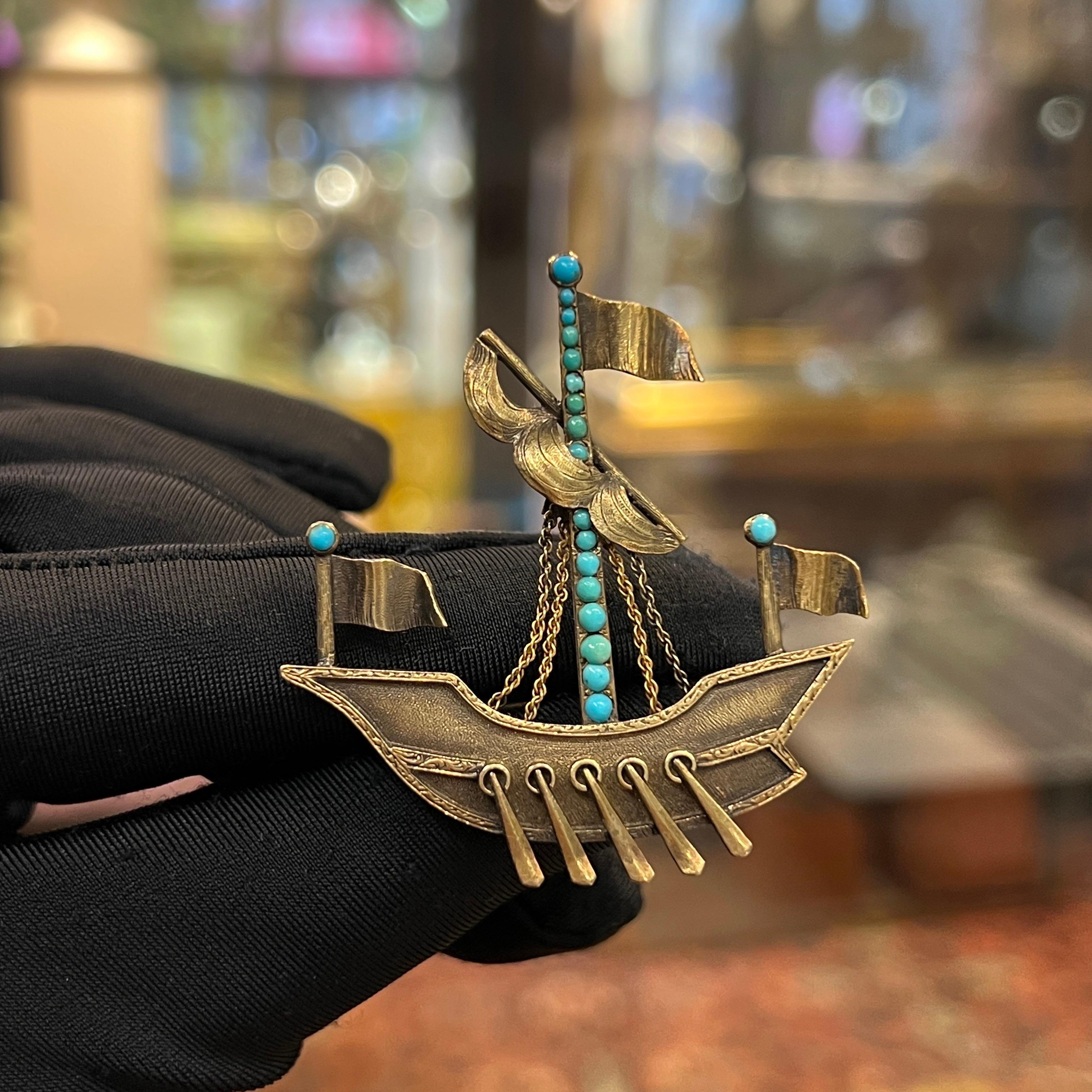 Antique Turquoise Ship Brooch
 
A yellow gold brooch in the shape of a ship adorned with round turquoise stones. 

Circa 1825
Approximate  Height: 2 inches 
Approximate Weight: 10 grams
Metal Type: 14 Karat Gold 