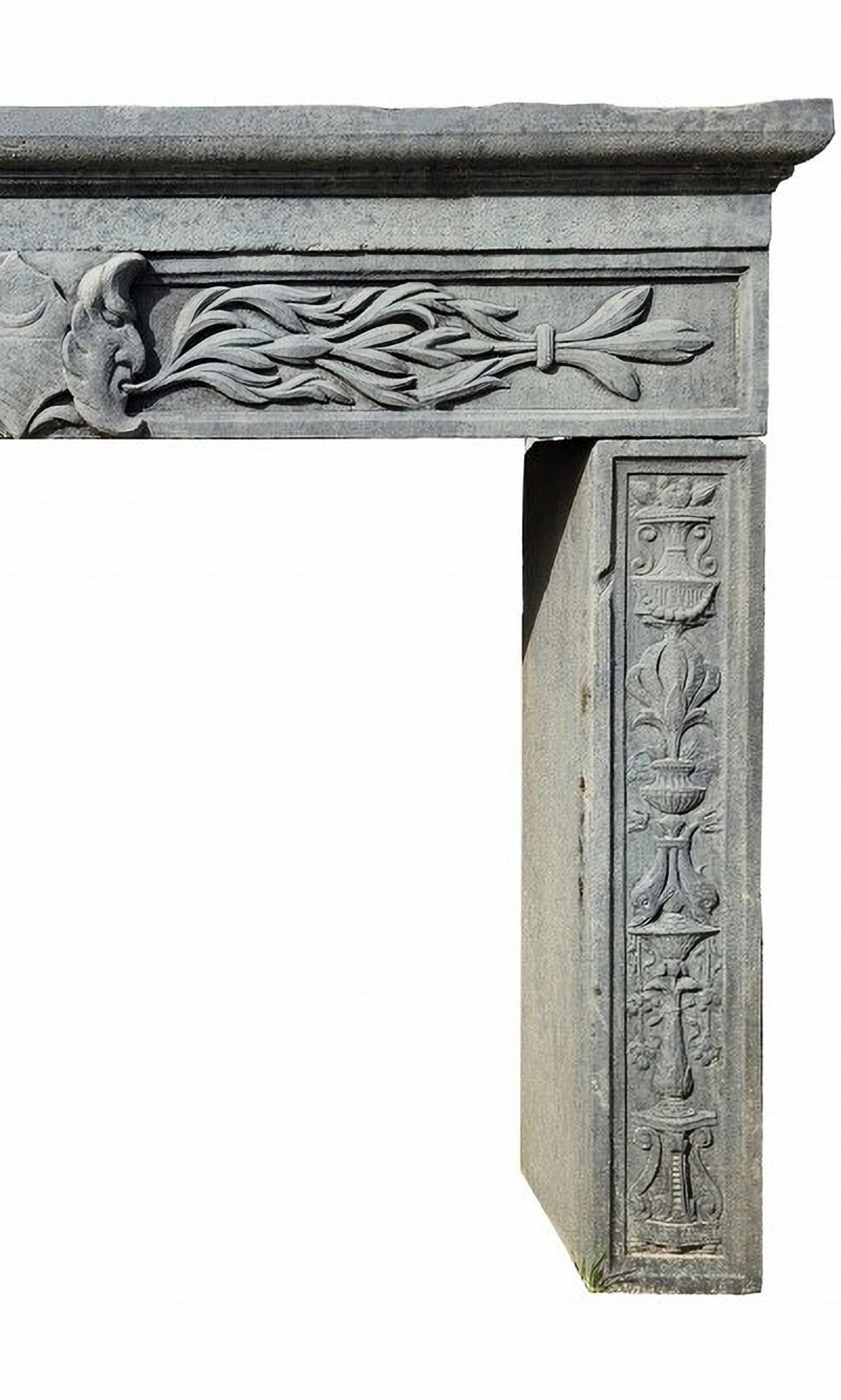 ANTIQUE TUSCAN PIETRA SERENA FIREPLACE
20th Century
Large gray sandstone fireplace. In the center two opposing satyrs protecting a noble coat of arms with a half moon collapsed in the upper half and with oblique bands in the lower half. From the