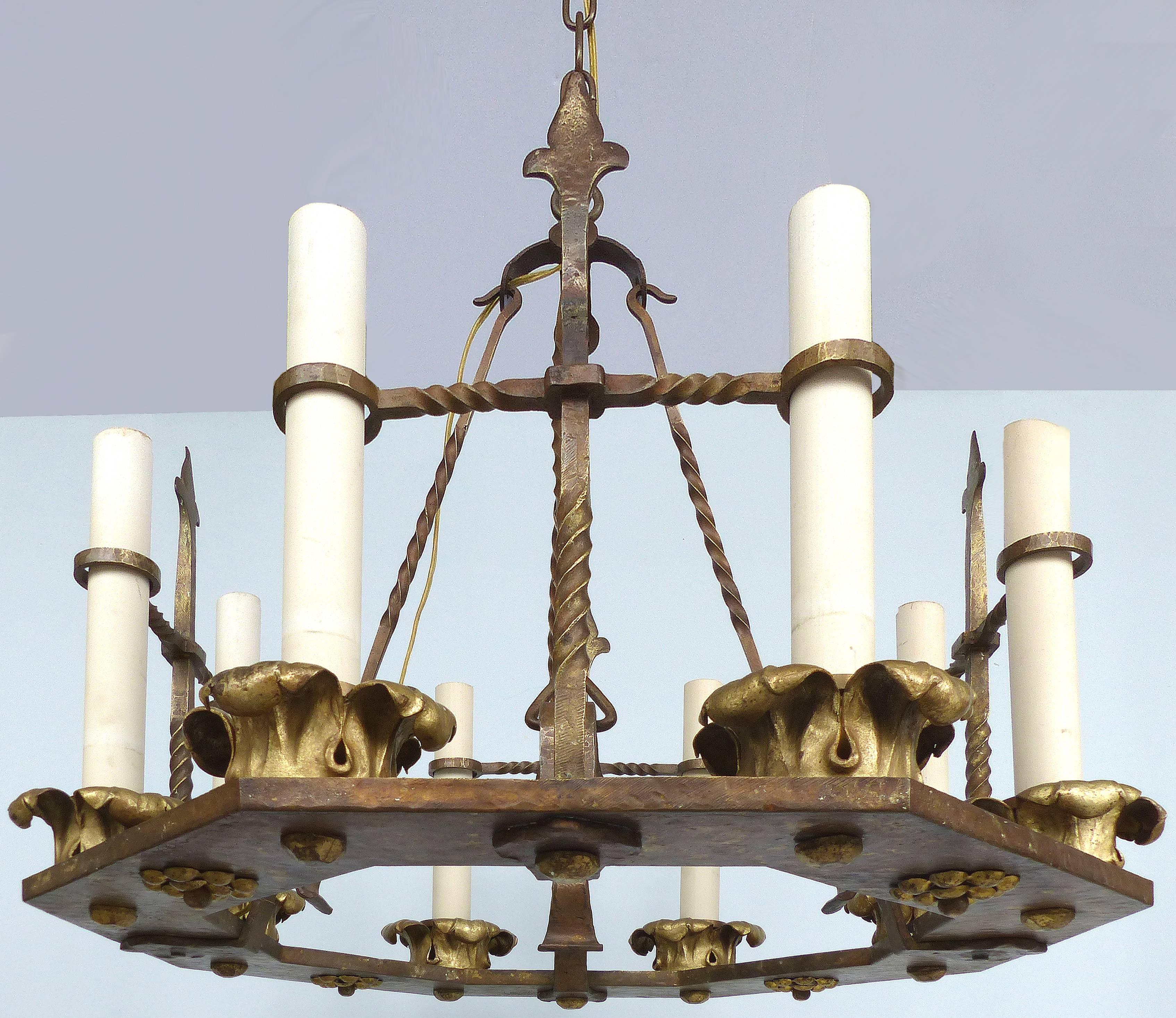 Antique Twelve-Light Forged Iron and Brass Chandelier

Offered for sale is an early 1900s antique forged iron twelve-light chandelier with brass acanthus leaf bobesches. The fixture is hexagonal with four twisted iron hanging rods which rise to a