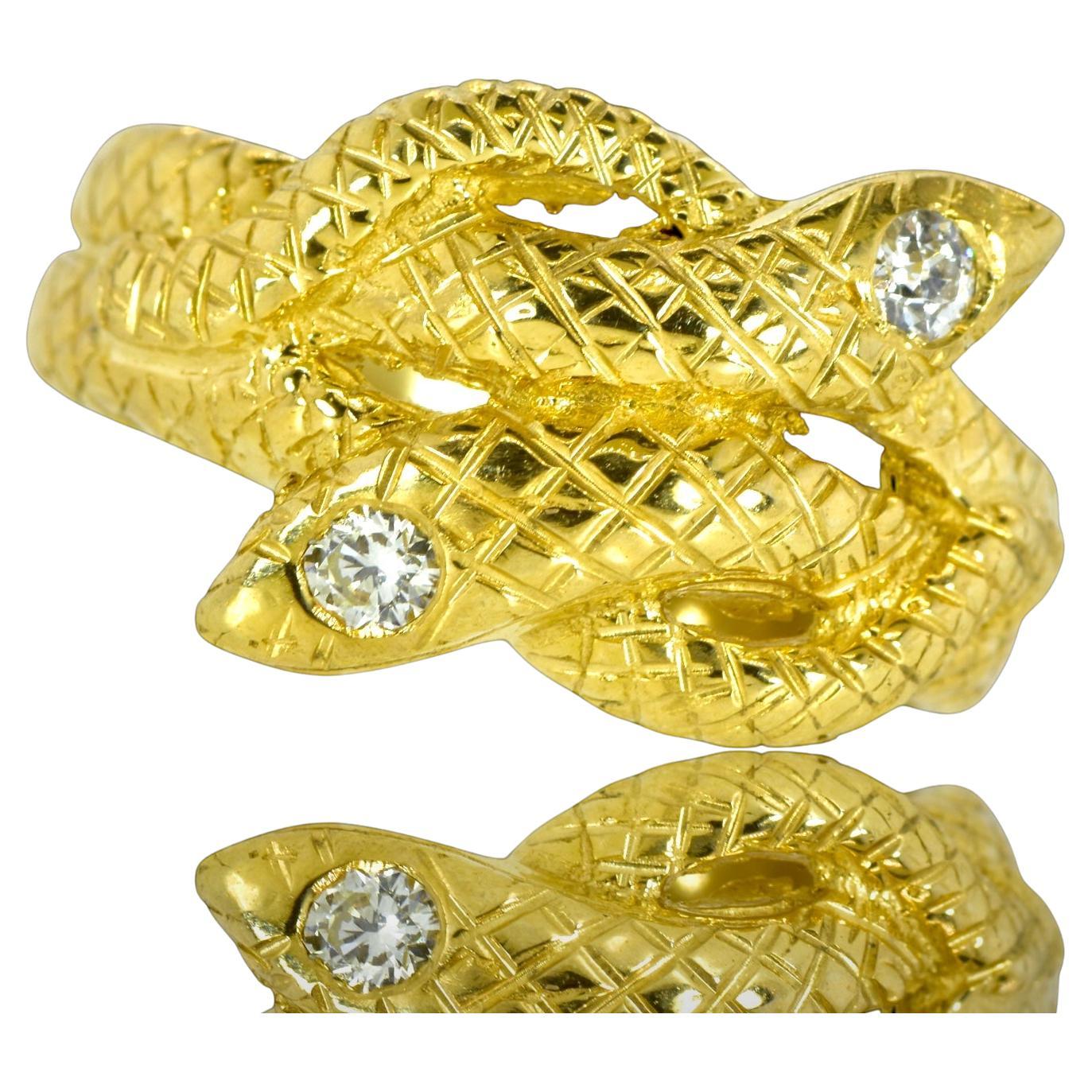 Antique twin serpent ring from the late 19th century symbolizing eternal love.  The two diamonds in the snakes' head are old mine cut  diamonds weighing totally 0.21 cts., near colorless, (H/I) and very slightly included to slightly included.  The