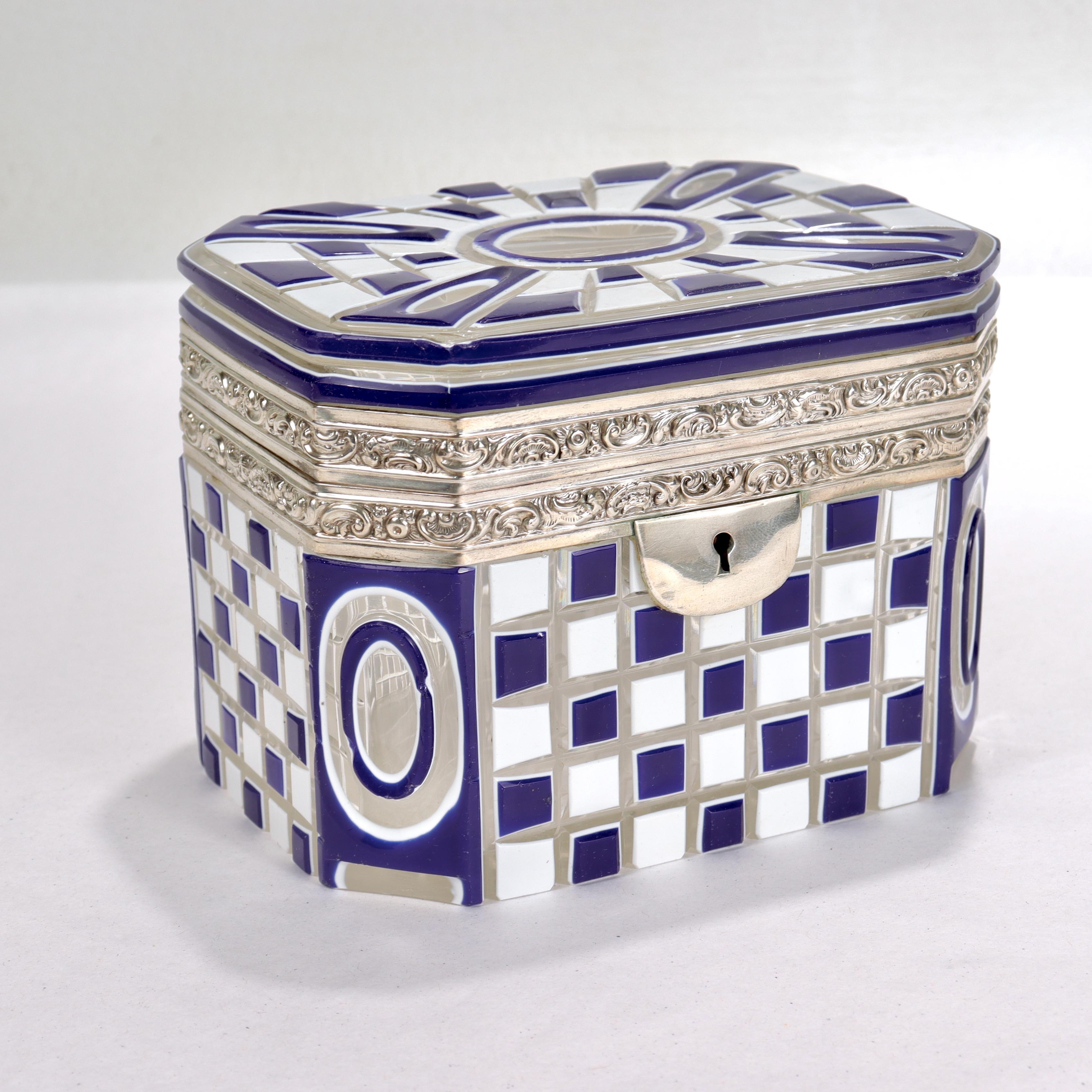 A fine antique Bohemian glass box or casket.

With an incredibly rare cut-to-clear two-color overlay design. 

The cut resembles machine turning with alternating blue & white checkboard patterns cuts to the sides and bullseye cuts to the chamfered