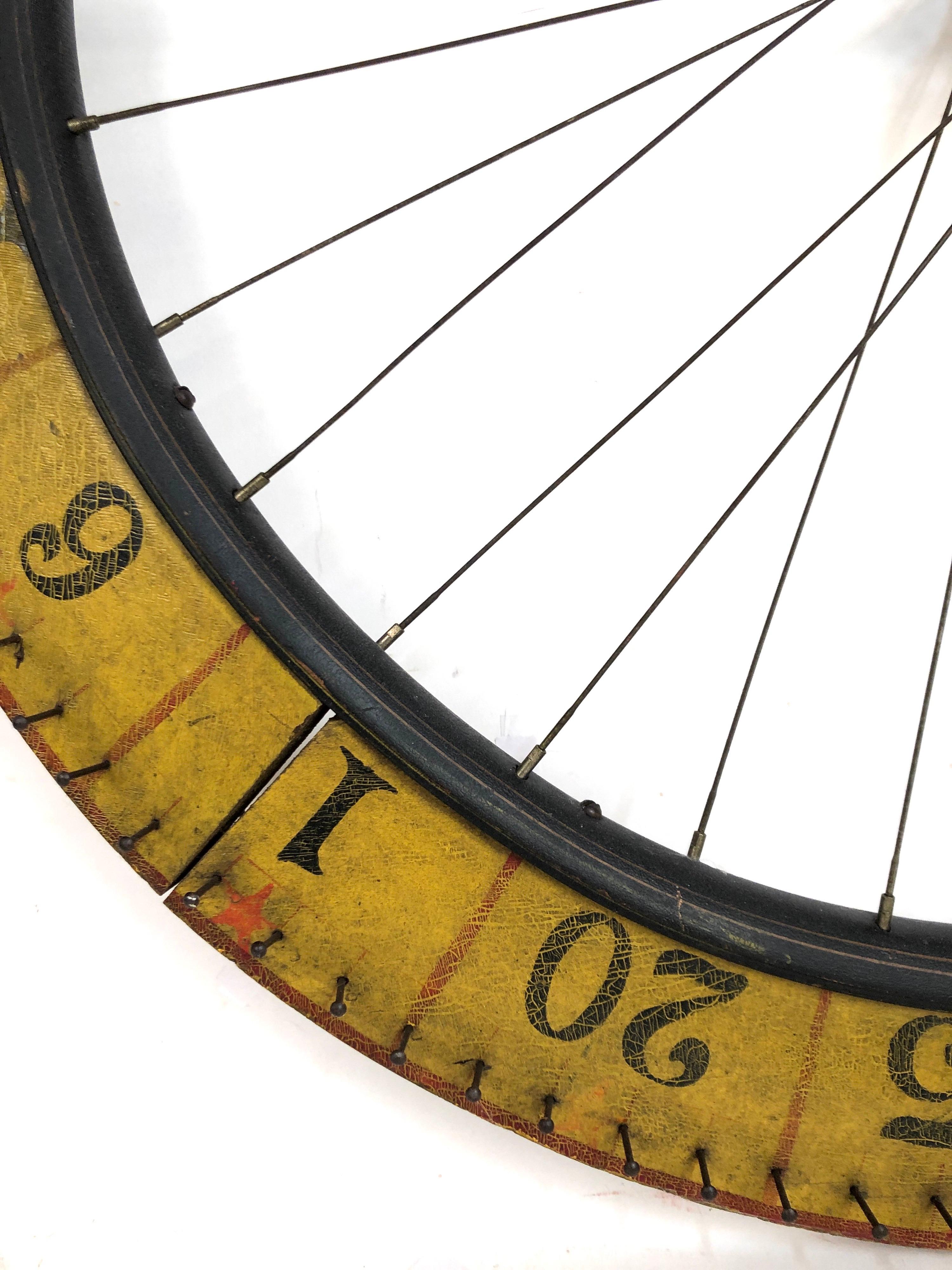 A nice colorful two sided bicycle wheel style antique carnival gaming wheel, circa 1930s. Great crackle aged surface. One side with smaller numbers the other with larger ones. Easy to hang and display.