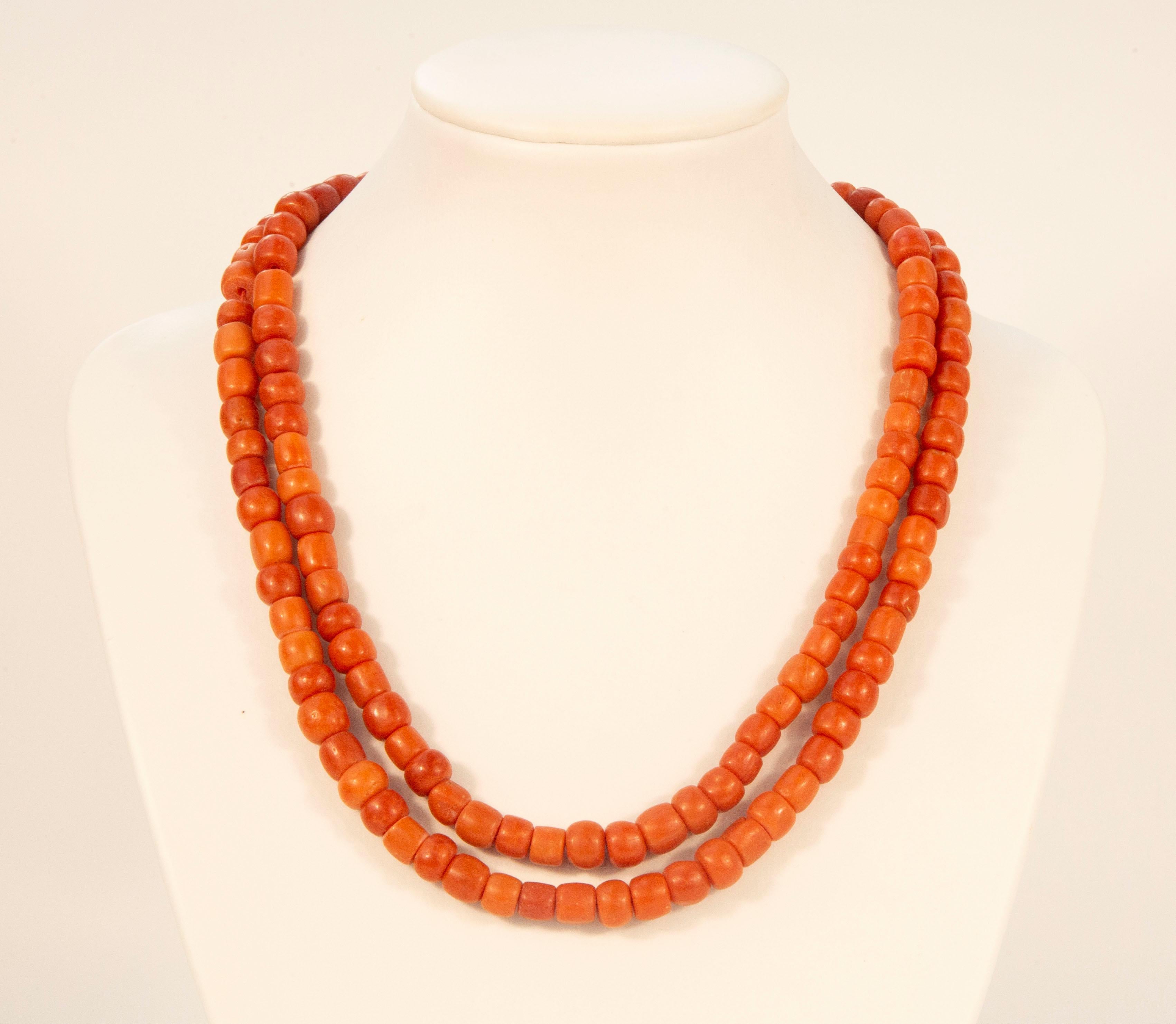 An antique two strand red coral necklace with a 14 karat rose gold barrel lock and a safety lock chain. The necklace was made at the beginning of the 20th century in the Netherlands, and it is marked with an oak leaf that is an antique Dutch mark