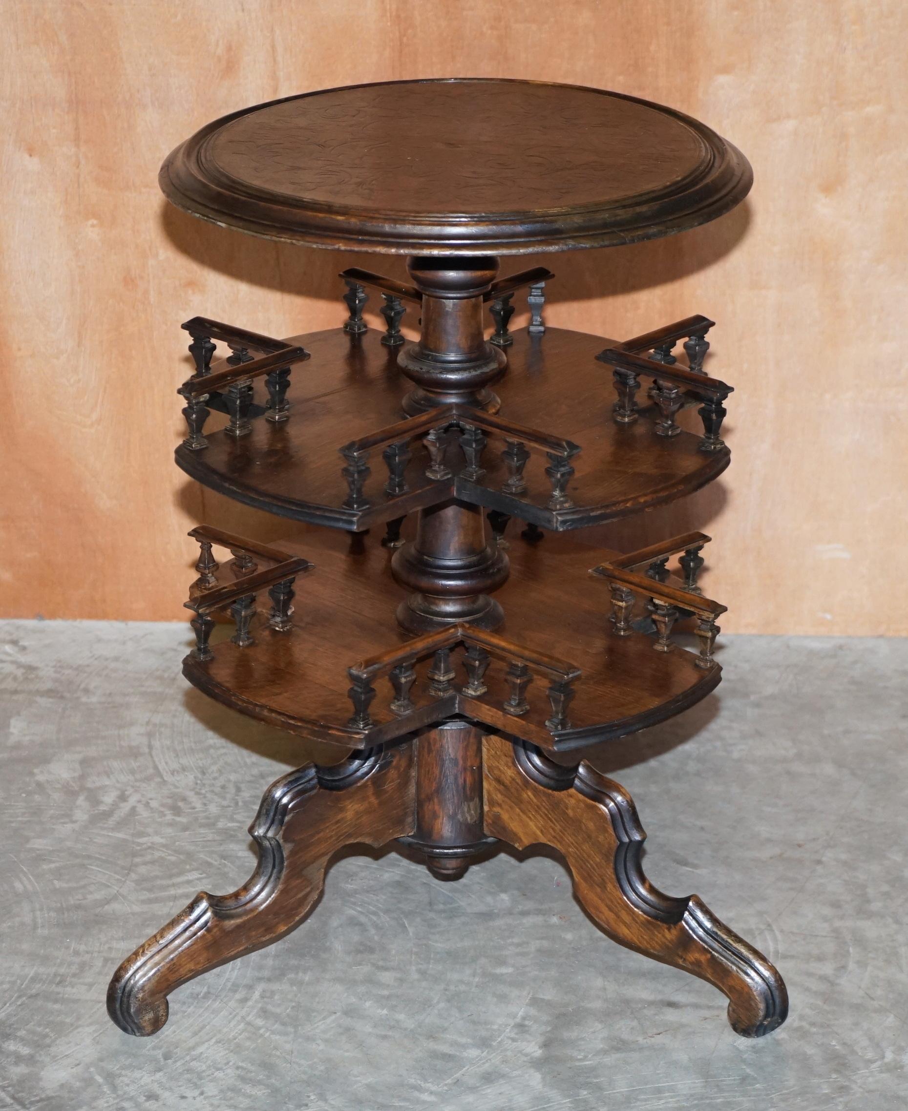 We are delighted to offer for sale this lovely original circa 1880 English Victorian two tier rotating book table with pokerwork top 

A very good looking, highly collectable and well made table. These were designed as book tables for your