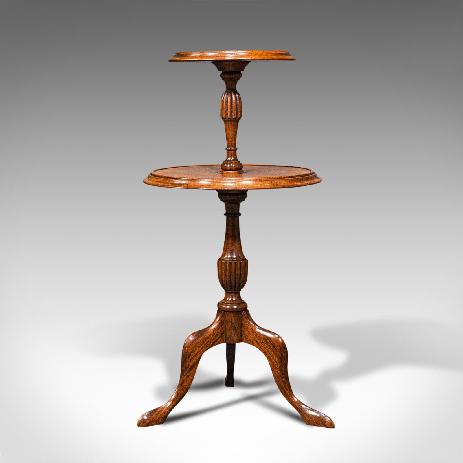 This is an antique two tiered table. An English, mahogany afternoon tea or cake stand, dating to the Edwardian period, circa 1910.

Elegantly serve afternoon tea with this Edwardian stand
Displaying a desirable aged patina throughout
Select