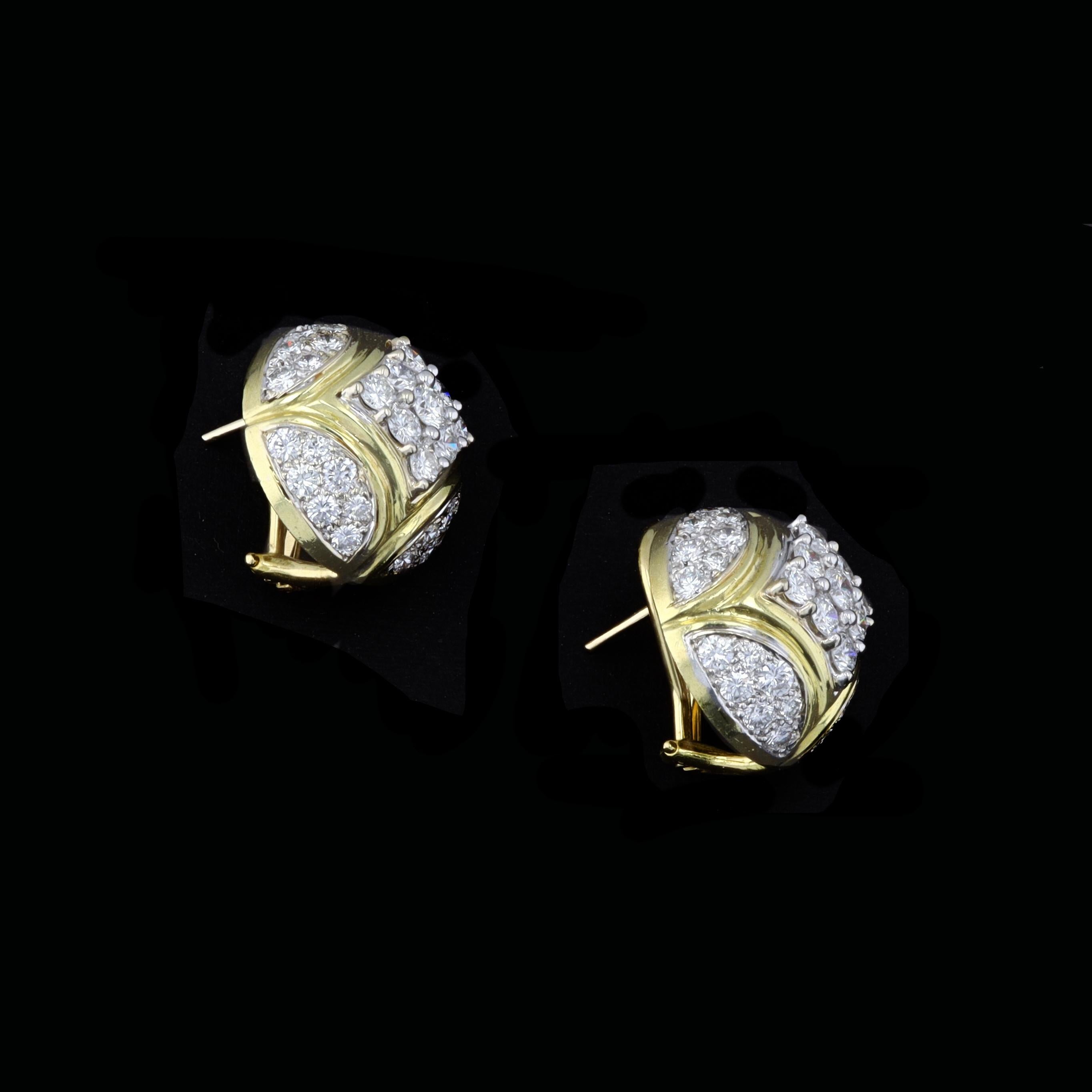 This beautiful pair of antique earrings are the perfect addition to any wardrobe. These earrings are set in 18K yellow and white gold. The earrings feature sparkling round cut diamonds that weigh approximately 3.50 carats total weight.

