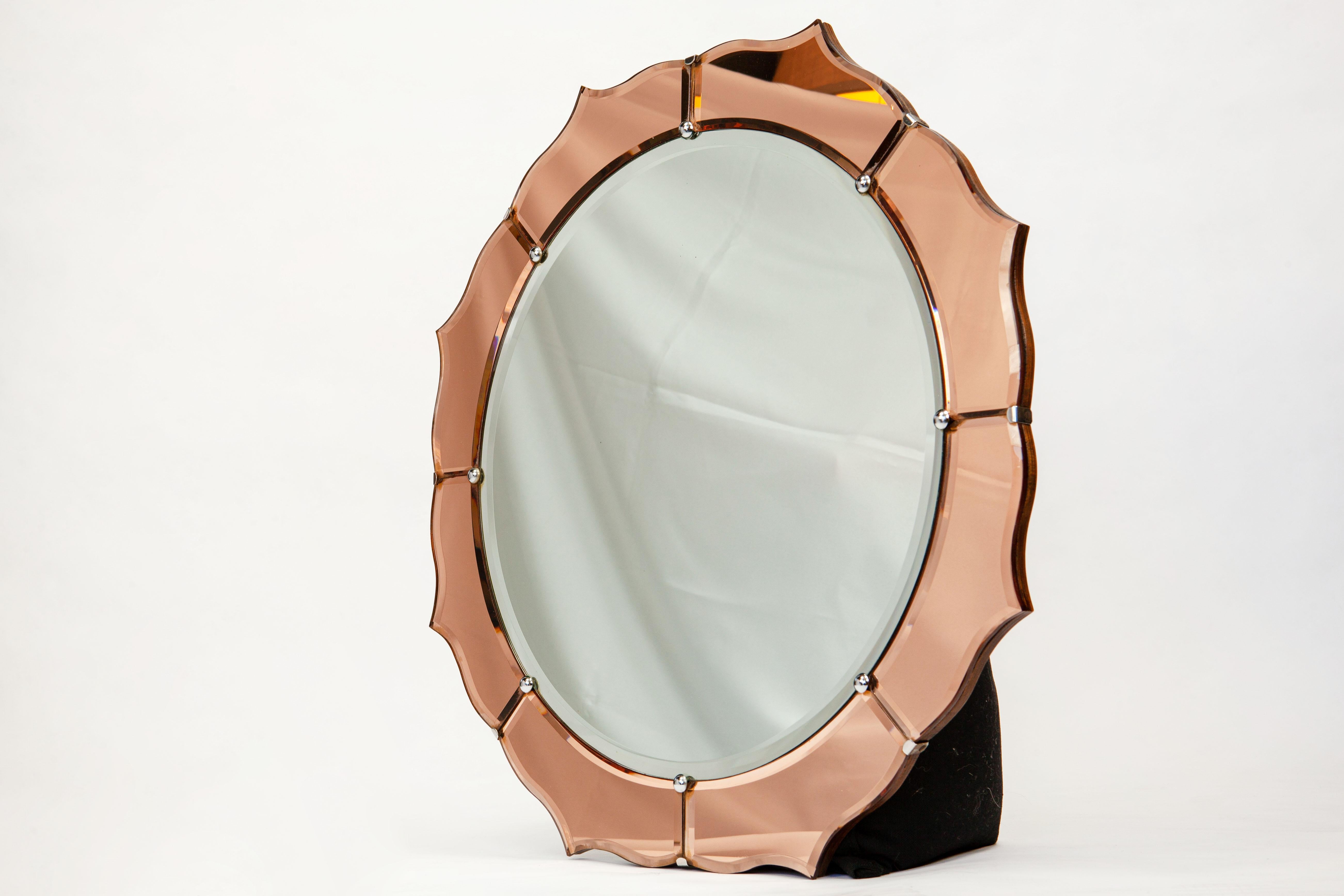 Antique two-tone English round mirror with beveled glass, wood back and chain hanger.