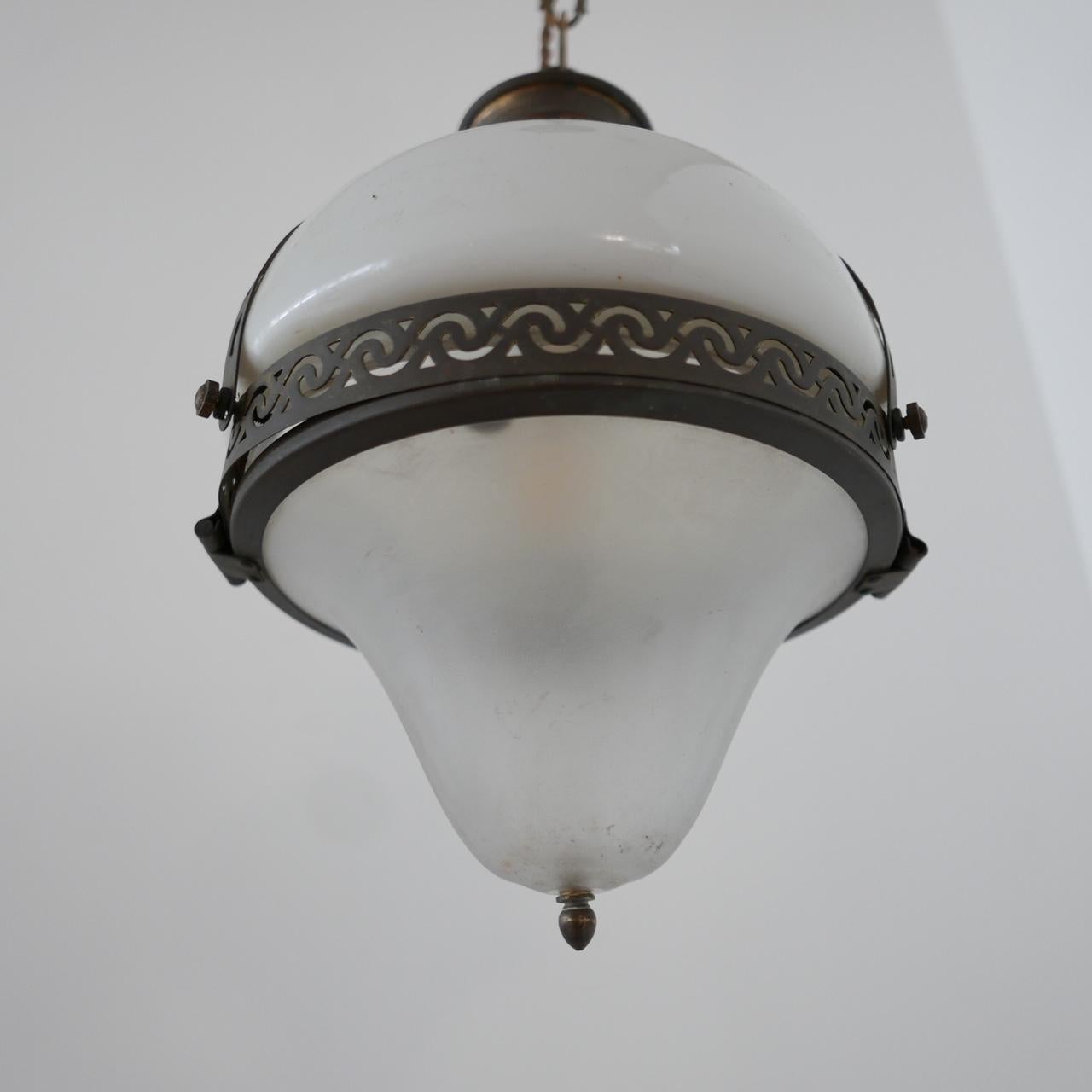 Early 20th century two-tone pendant light.

French, formed from brass rim and gallery.

Opaline top and etched glass base terminating in a brass point at the base. 

Re-wired and PAT tested. With original chain and rose. 

Dimensions: 33