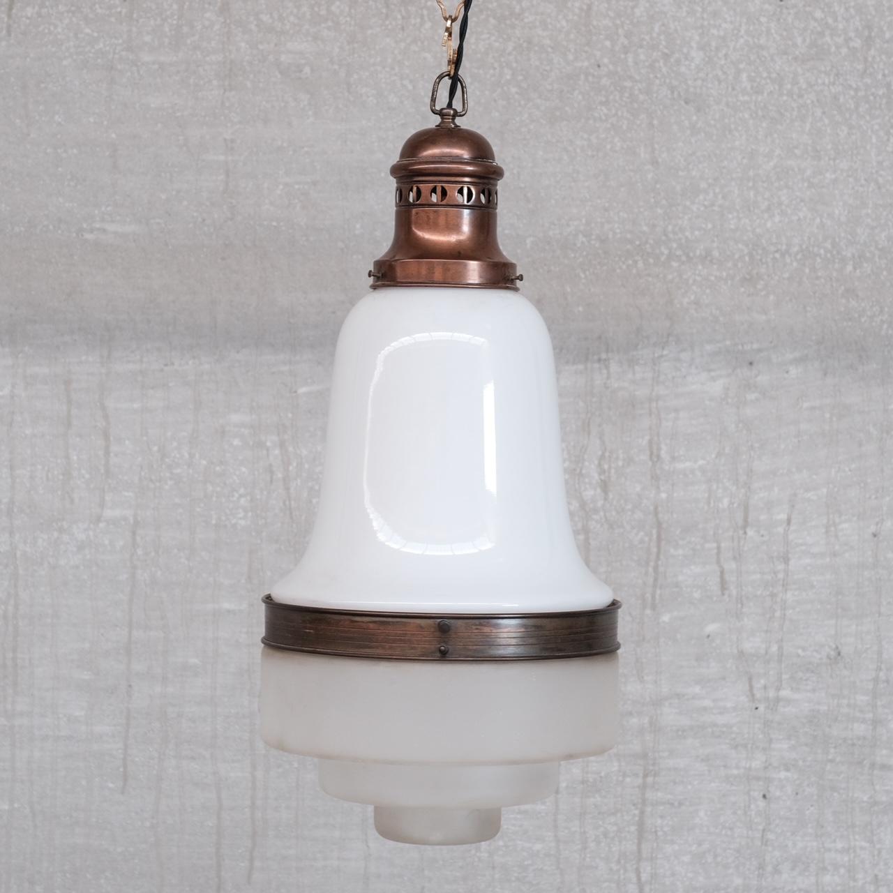 A two tone pendant light. 

France, c1930s.

Opaline glass top, with stepped etched glass base. 

Copper Gallery and rim. 

No chain or rose was retained, both can be sourced easily online. 

Since re-wired and PAT tested. 

Location: