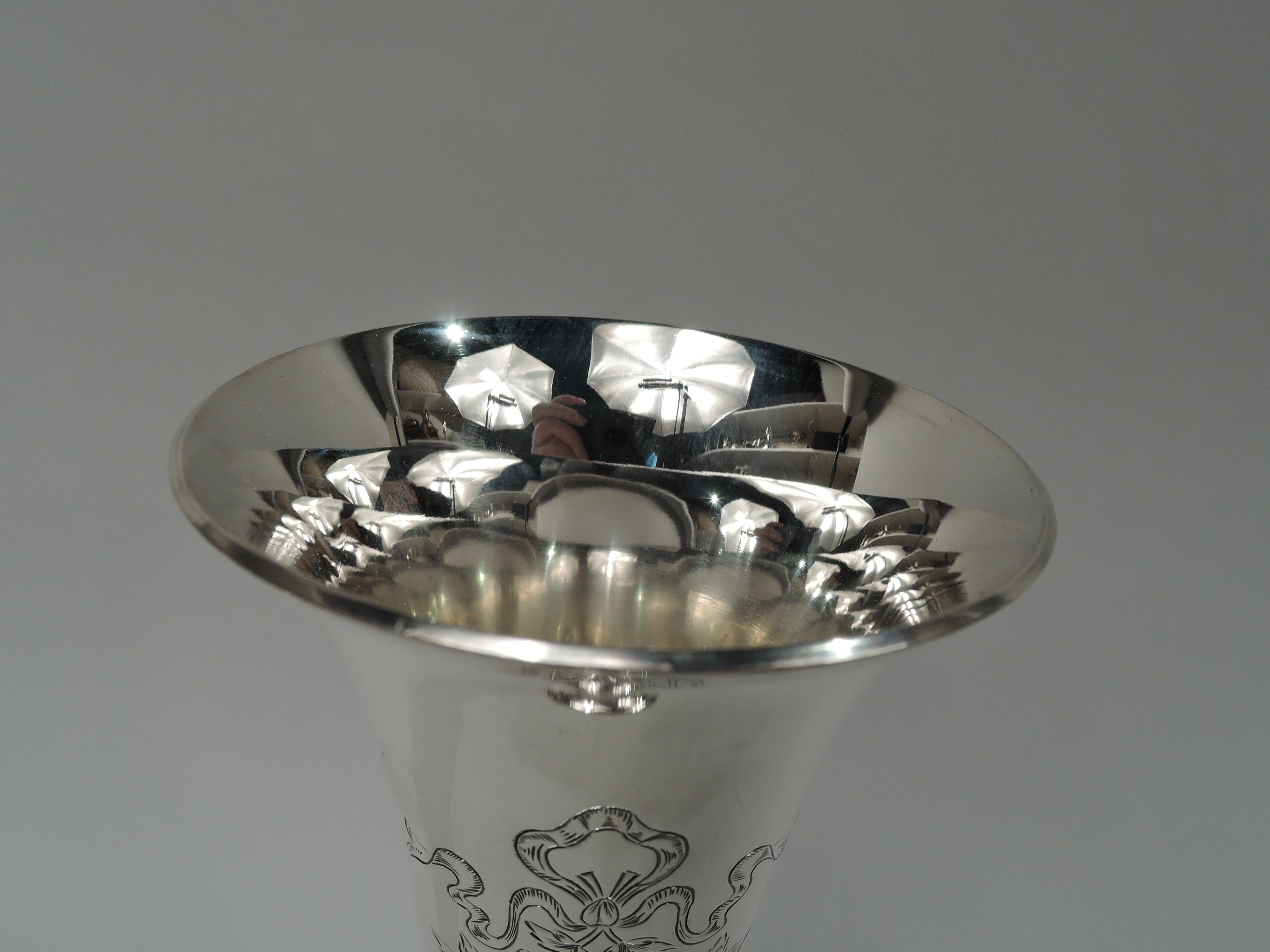 Edwardian sterling silver trumpet vase. Made by Unger Bros in Newark, circa 1910. Conical with flared rim and domed foot. Engraved ribboned wreath with pendant flowers (vacant). Fully marked including maker’s stamp and no. 09792. Weight: 7.3 troy