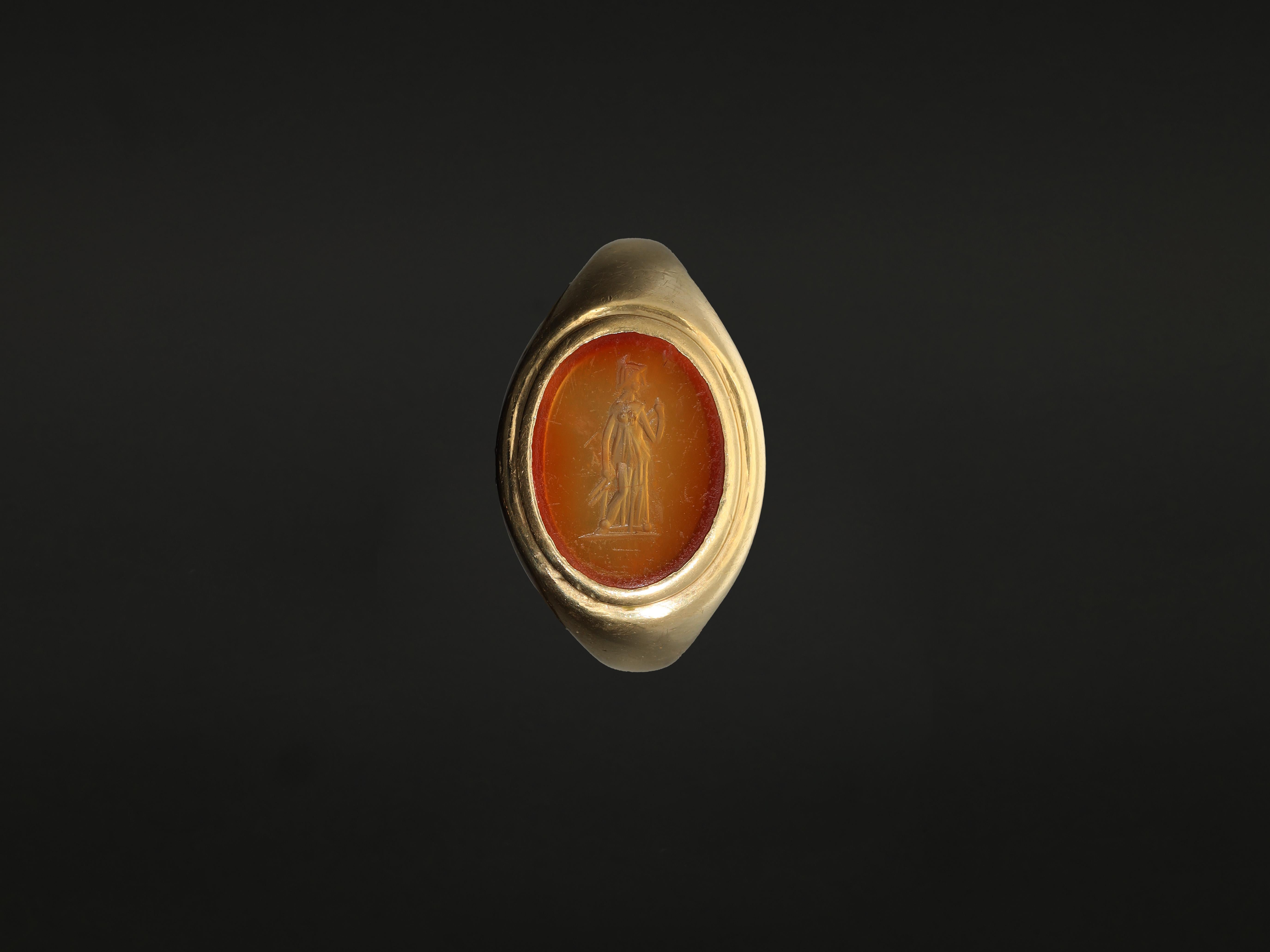A chunky unisex signet ring with an orange agate intaglio. This very heavy - 13.4 grams - antique intaglio ring feels nice and substantial when worn. Set with an ancient carnelian (orange agate) oval intaglio, this ring is crafted in solid 18k