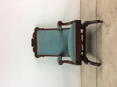 Antique Upholstered Rocking Chair with Carved Wood Detailing
