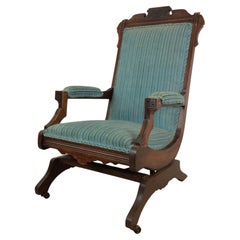 Antique Upholstered Rocking Chair with Carved Wood Detailing