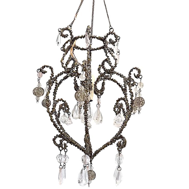 A circa 1920's American beaded crystals chandelier with an interior candelabra light and uranium glass pendants that glow in the dark.

Measurements:
Height: 22.5