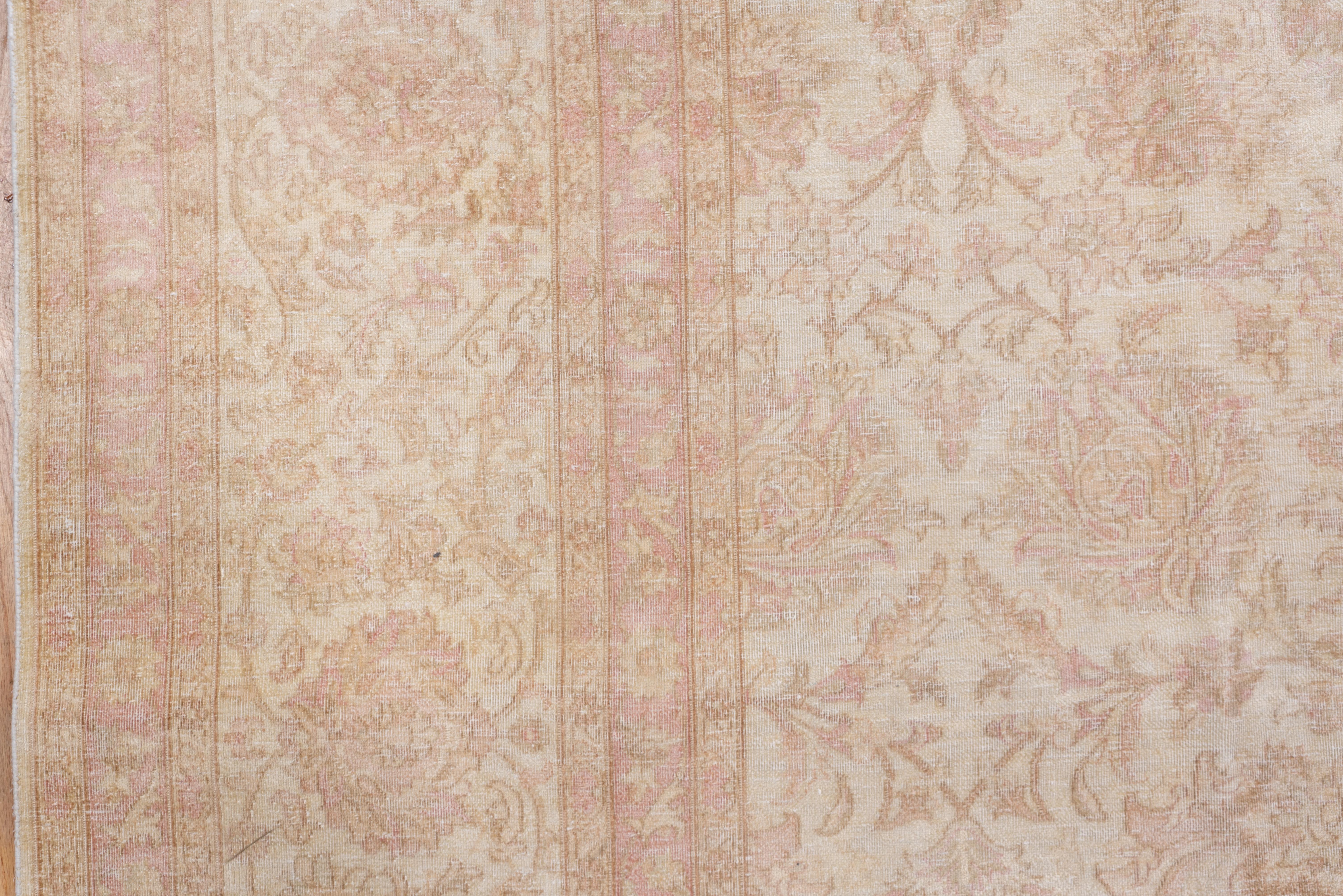 The light almost shadow pattern in ecru, beige and tan is based around a central array of rosettes with more palmettes, scrolling vinery and other floral forms set around. Urban Turkish carpet in good condition.
 