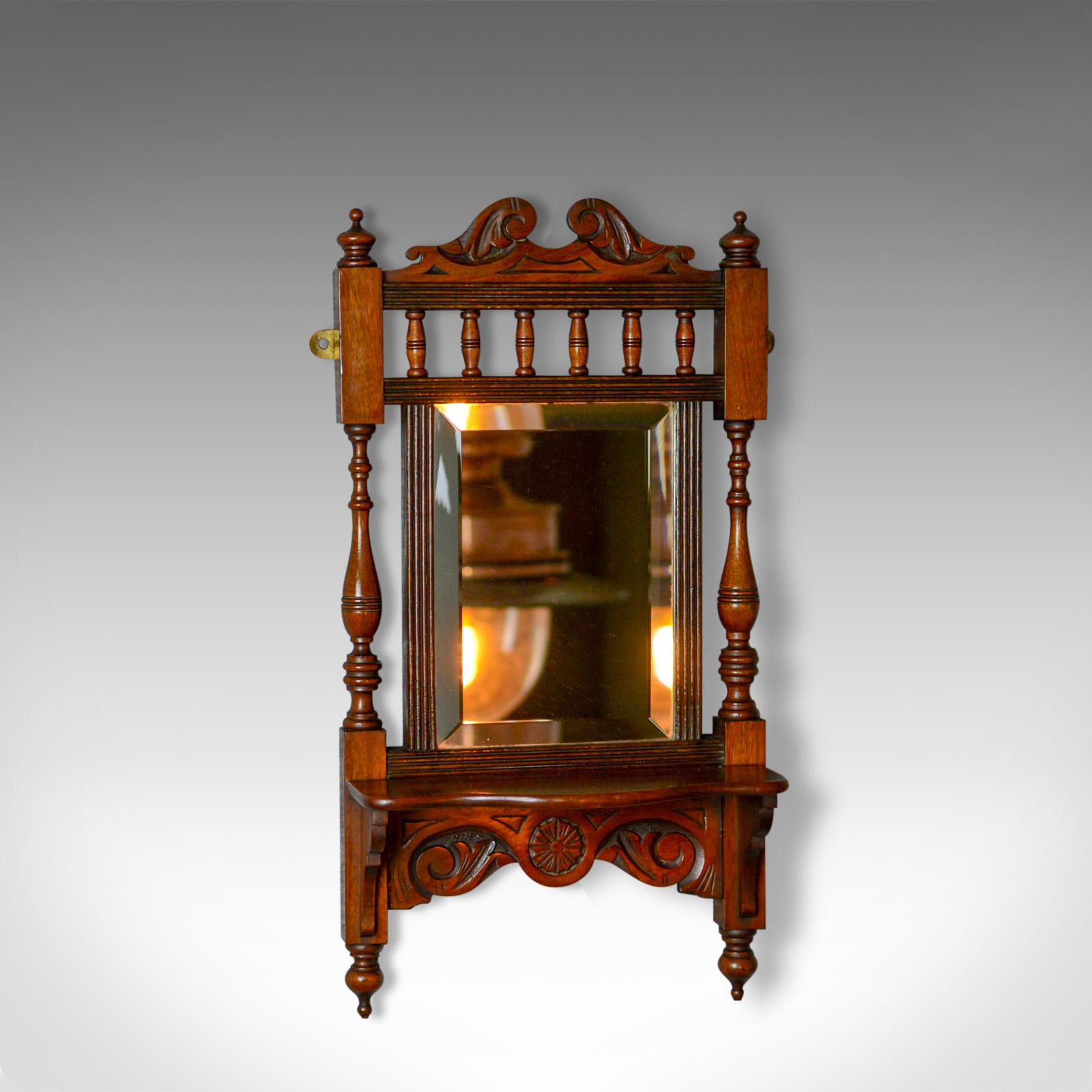 This is an antique valet mirror. An English, Edwardian, small, walnut, wall mirror with shelf dating to the early 20th century, circa 1910.

Delightful biscuit tones to the English walnut
Grain interest and a desirable aged patina
Small wall