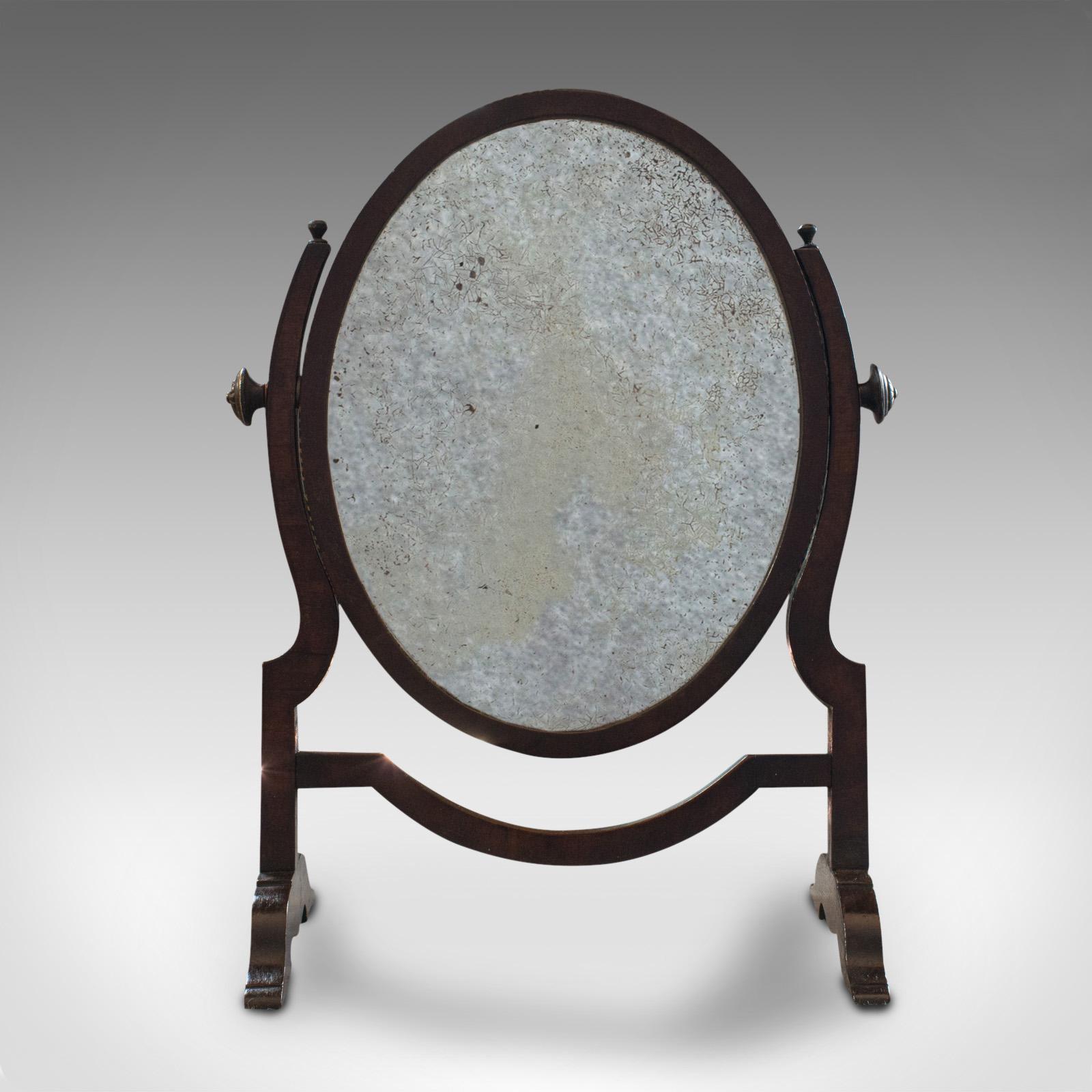 This is an antique vanity mirror. An English, oak and mahogany dresser mirror, dating to the Regency period, circa 1820.

Pleasingly distressed mirror
Displays a desirable aged patina
Oak frame with mahogany detail
Original plate glass shows