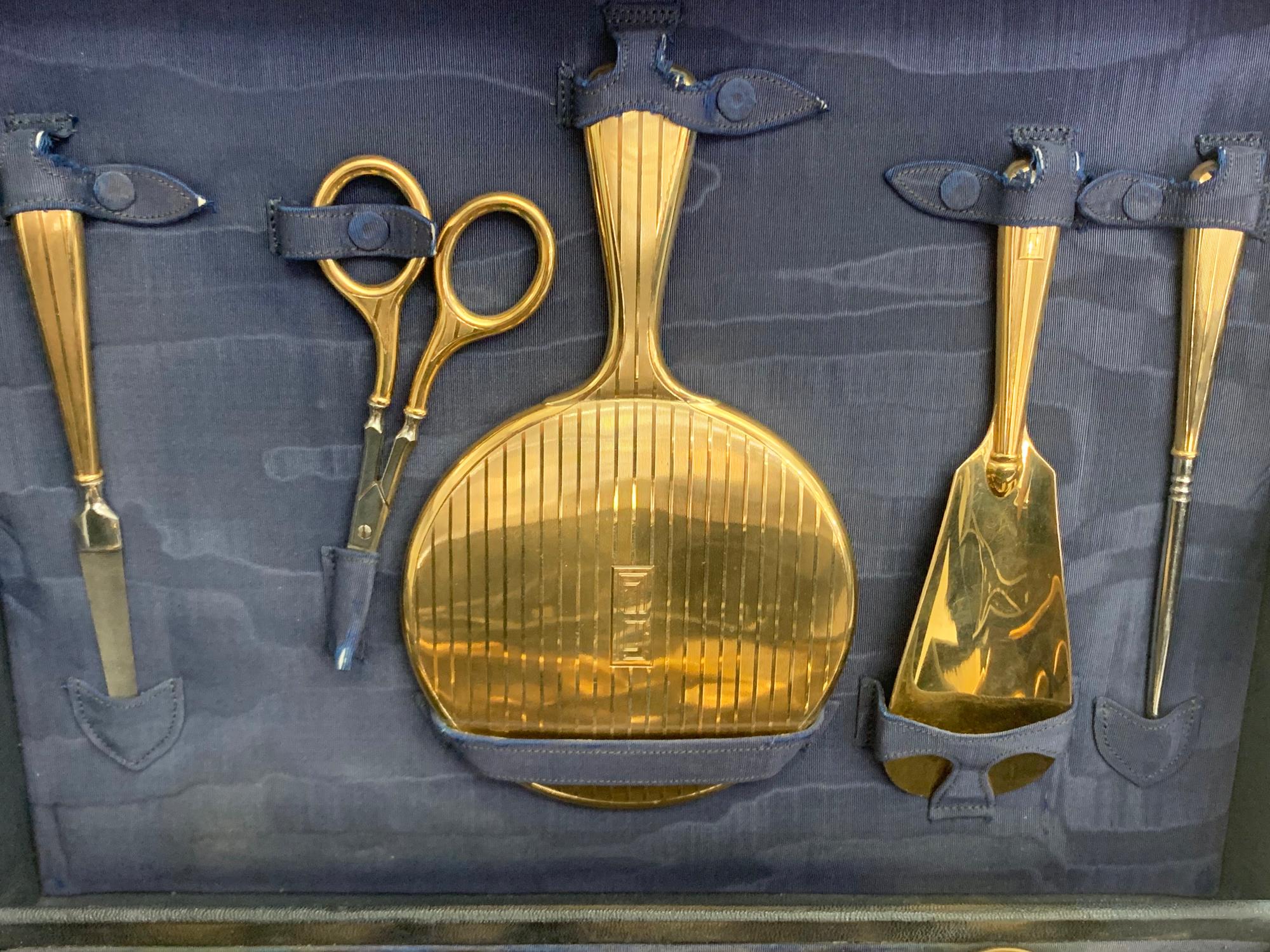 A wonderfully rare antique 14K gold dresser set contains 18 pieces including:

1 hair brush
1 hair comb
1 clothes brush
3 round gold containers
2 glass bottles
3 gold bottles
1 corsette hook
1 shoe horn
1 mirror
1 scissors
1 nail file
1 toothbrush