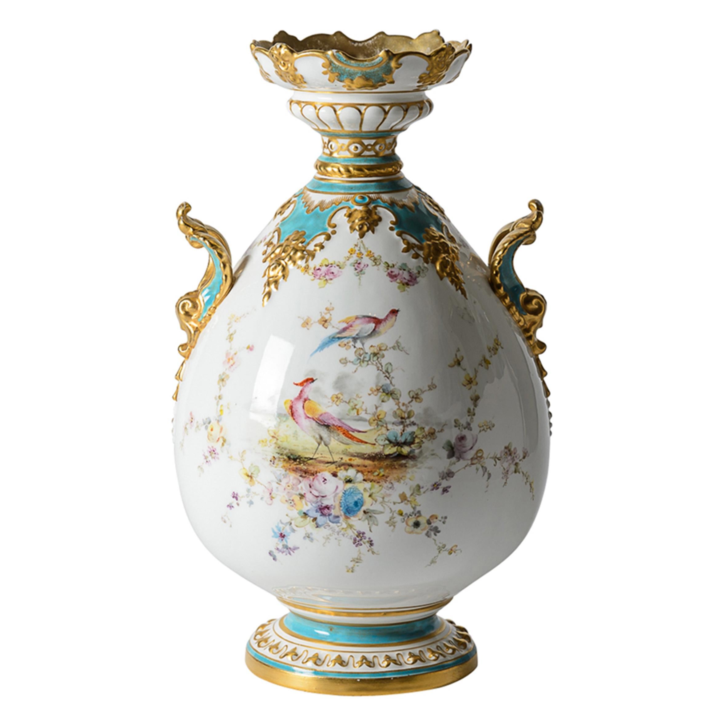 From one of the world's re known porcelain factories of England: Royal Crown Derby. This vase features exquisite shape and modeling with vibrant turquoise accents and hand accented 24 karat gold throughout. The pheasants on the main panel as well as