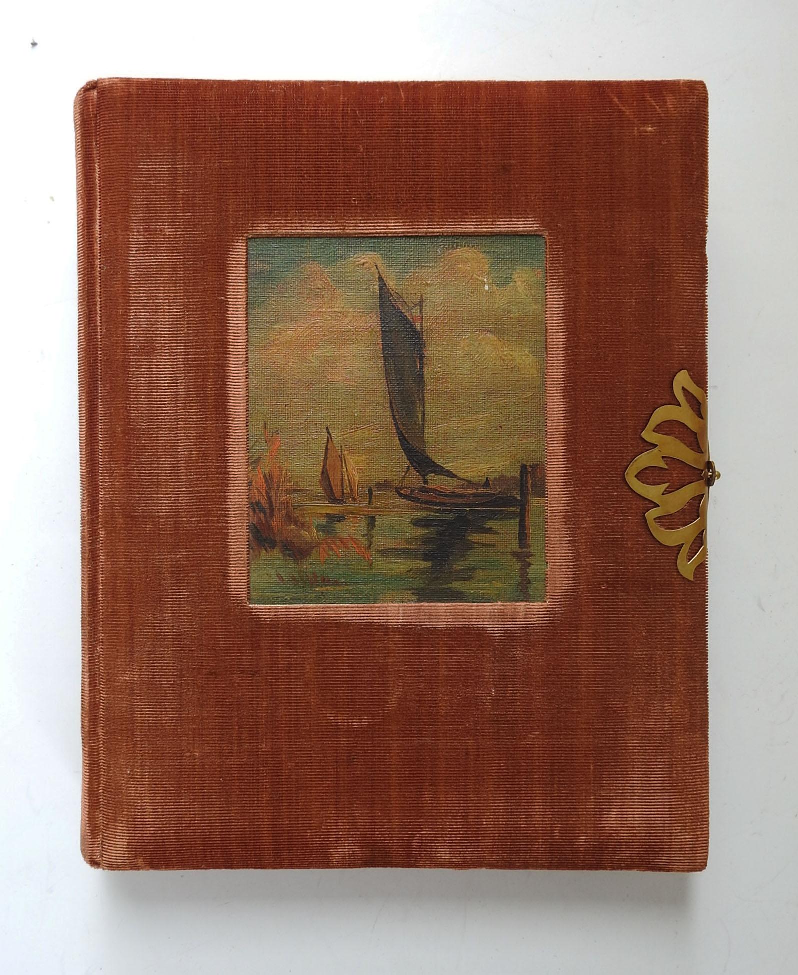 Circa 1920's velvet photo album, never used.  Covered in rust velvet with oil on canvas board painting of sail boats inlaid on cover.  Interior is .25