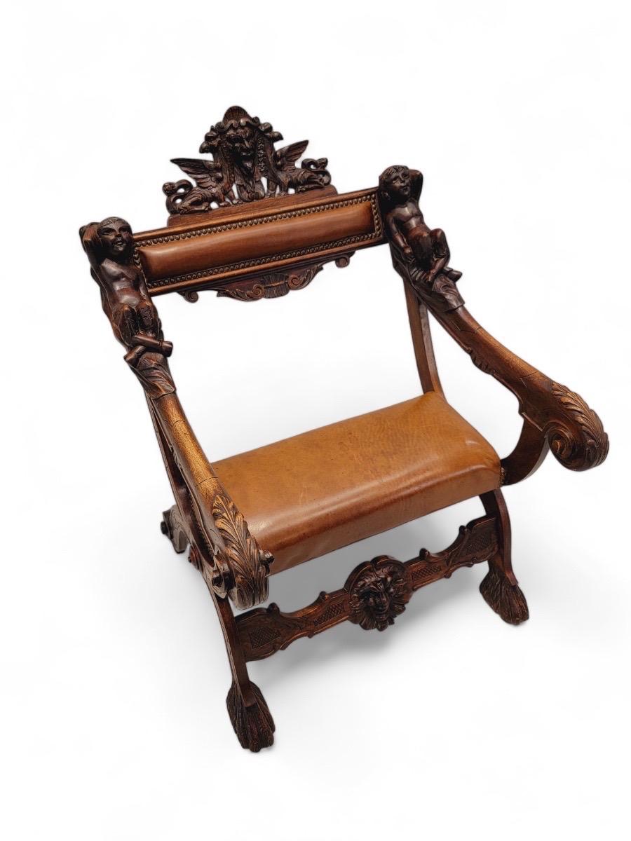 Antique Venetian 18th Century Baroque Style Hand-Carved Walnut Armchair with Brown Leather Upholstery

This stunning armchair showcases intricate hand-carved details in the Baroque style, reflecting the opulence and grandeur of the 18th century.