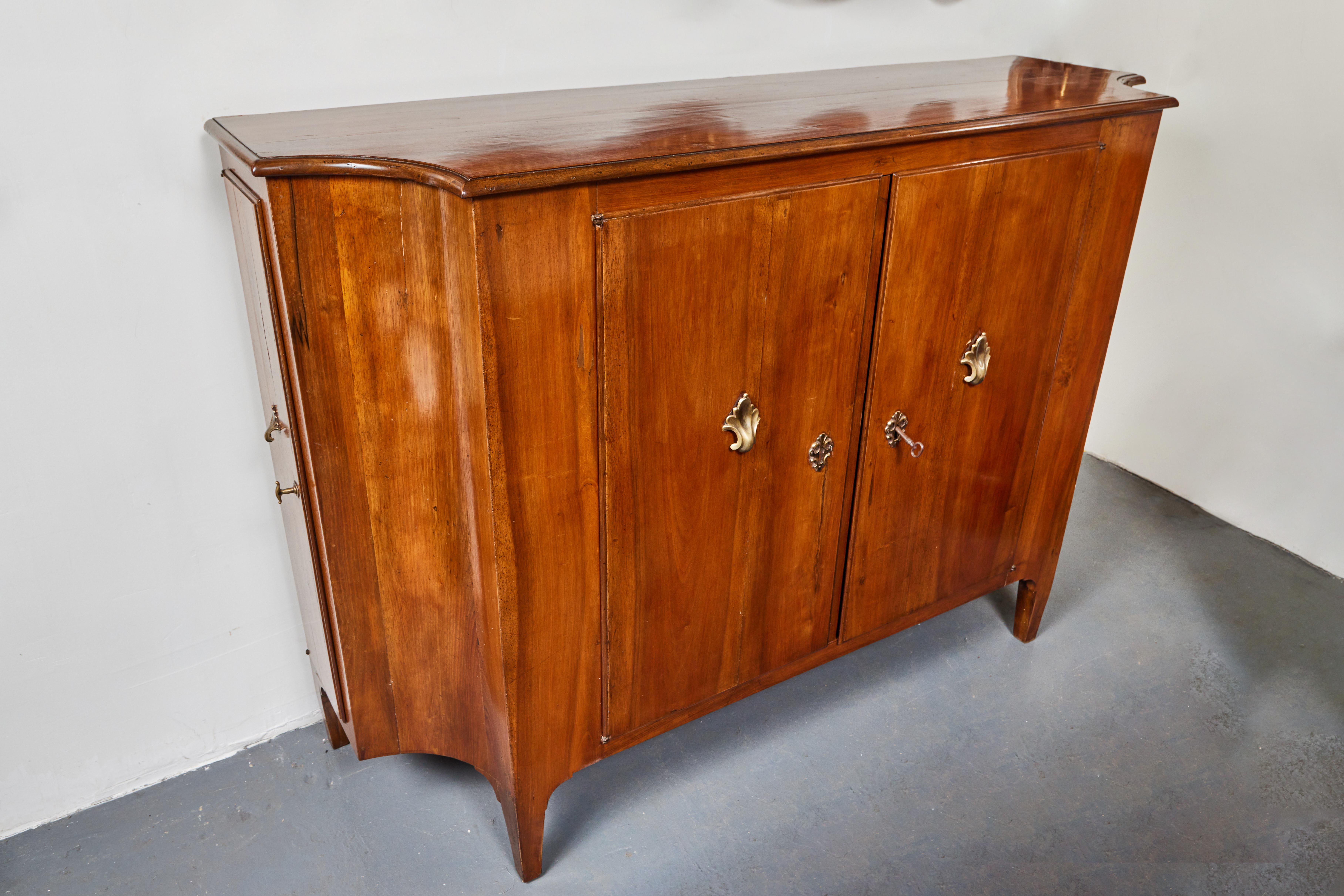 A chic, c. 1825, slim profile, hand-carved, solid pecan, scoop sided, four door buffet with original, gilt bronze hardware.